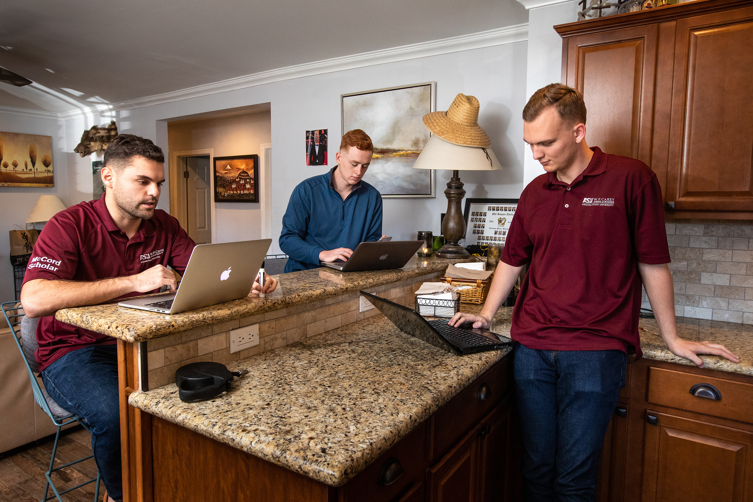 W. P. Carey School of Business seniors Tristan Gaynor, left, George Heiler, and Kevin Murphy, right, relax at their Tempe home before classes Friday, Jan. 18, 2019. 