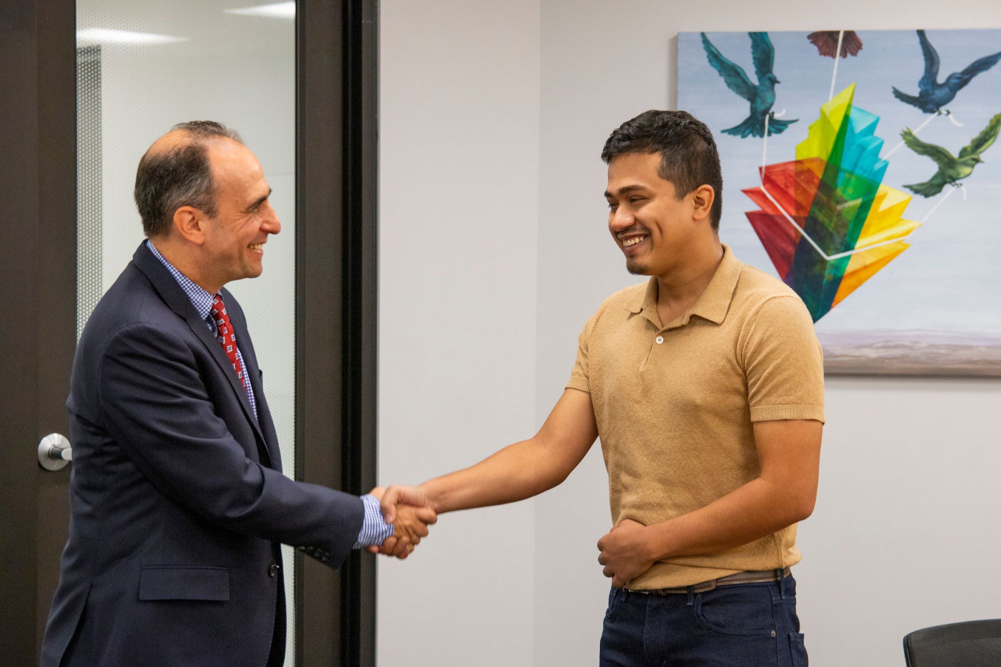 Teets award winner Subham Sharma shakes the hand of Associate Dean Dan Gruber.