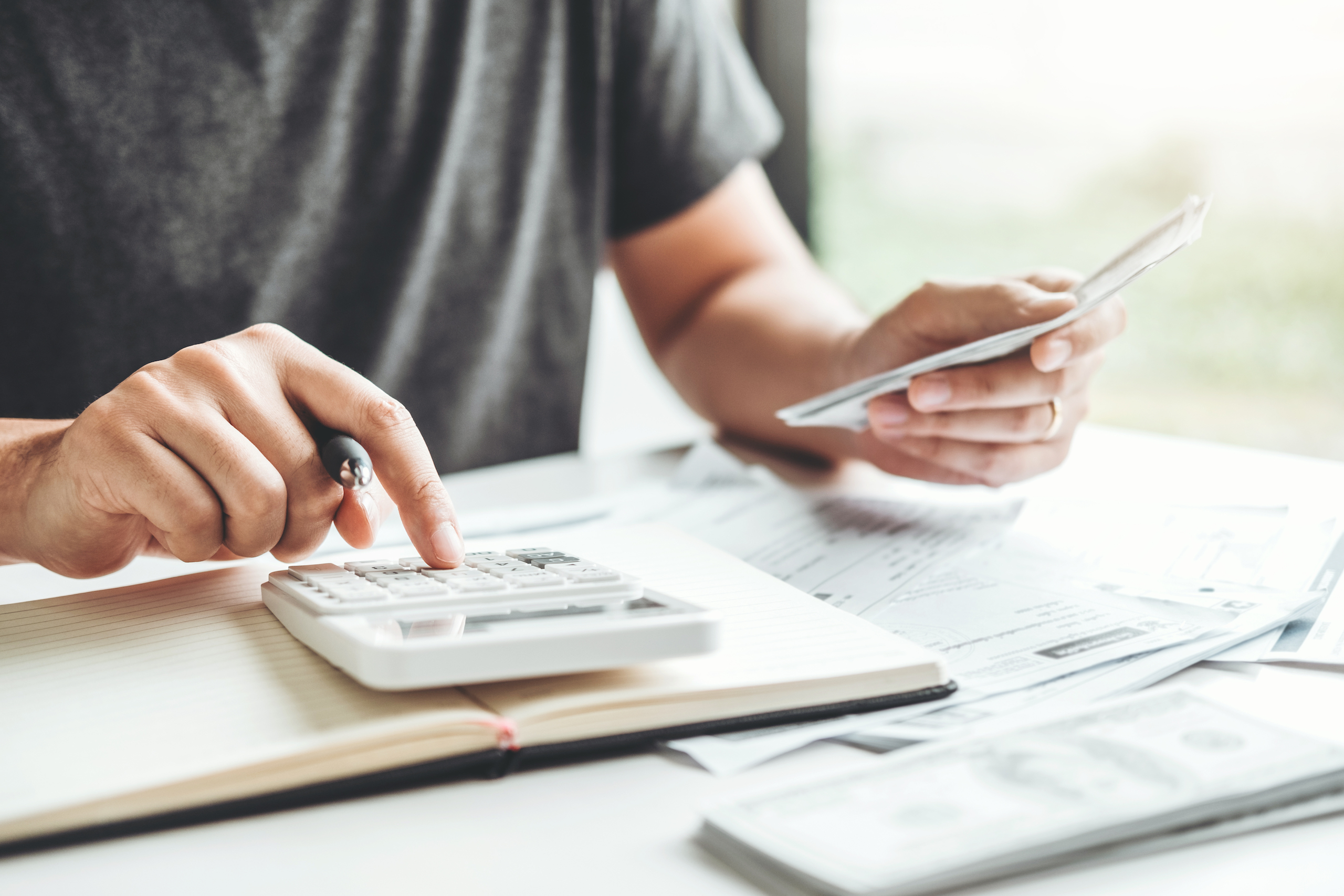 Man using calculator accounting calculating cost