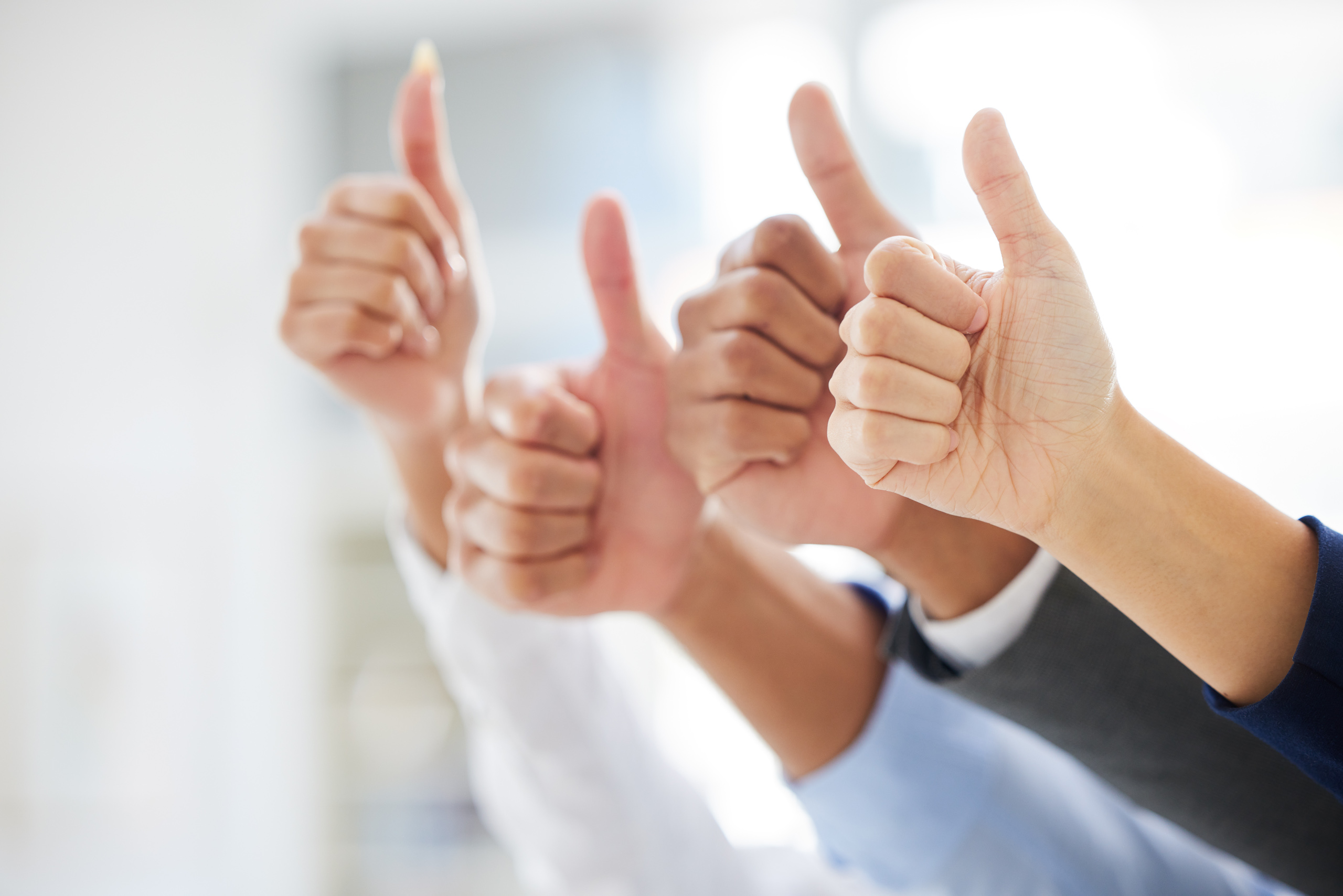 Closeup of unknown group of diverse businesspeople showing thumbs up sign and symbol in interview. Applicant team celebrating success. Candidates selected for job opening, vacancy, office opportunity