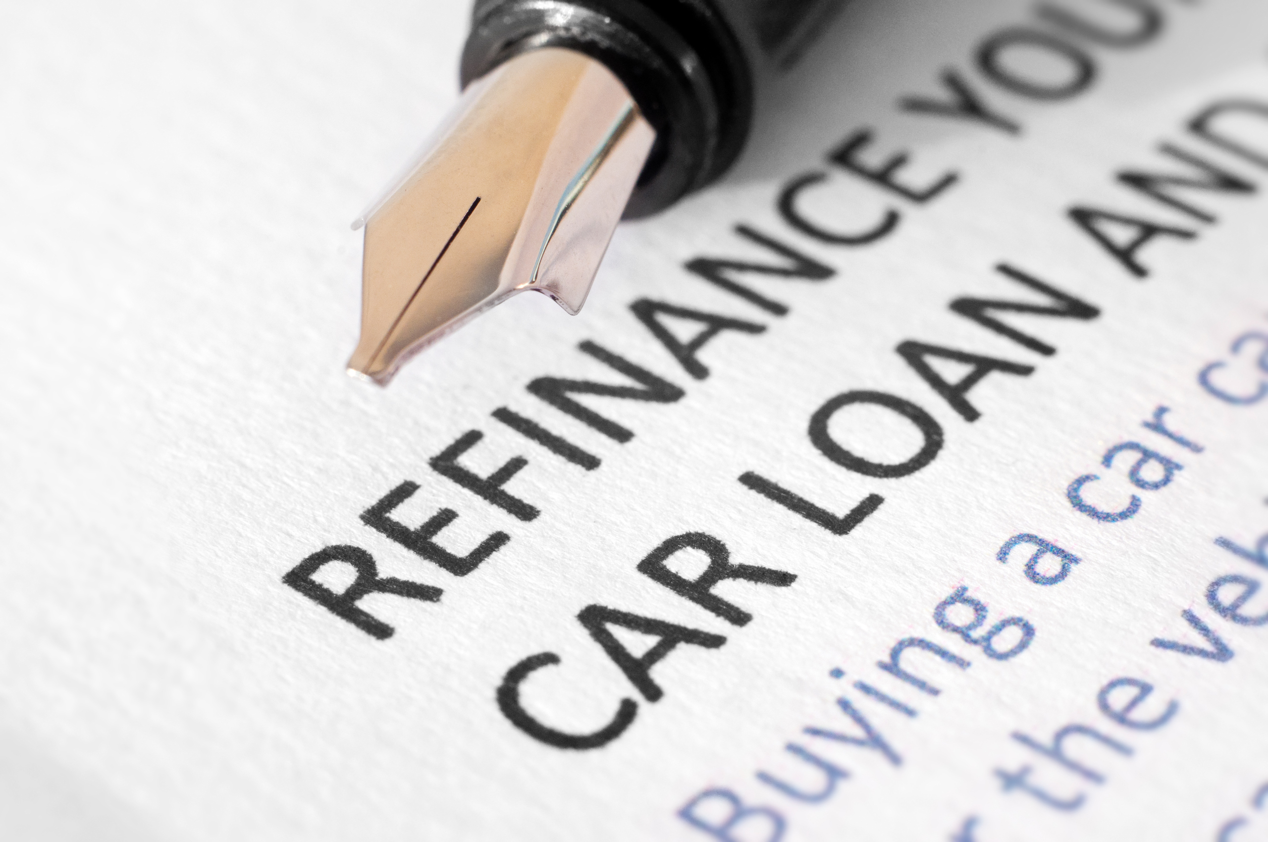 Close-up of Refinance your car loan document with pen