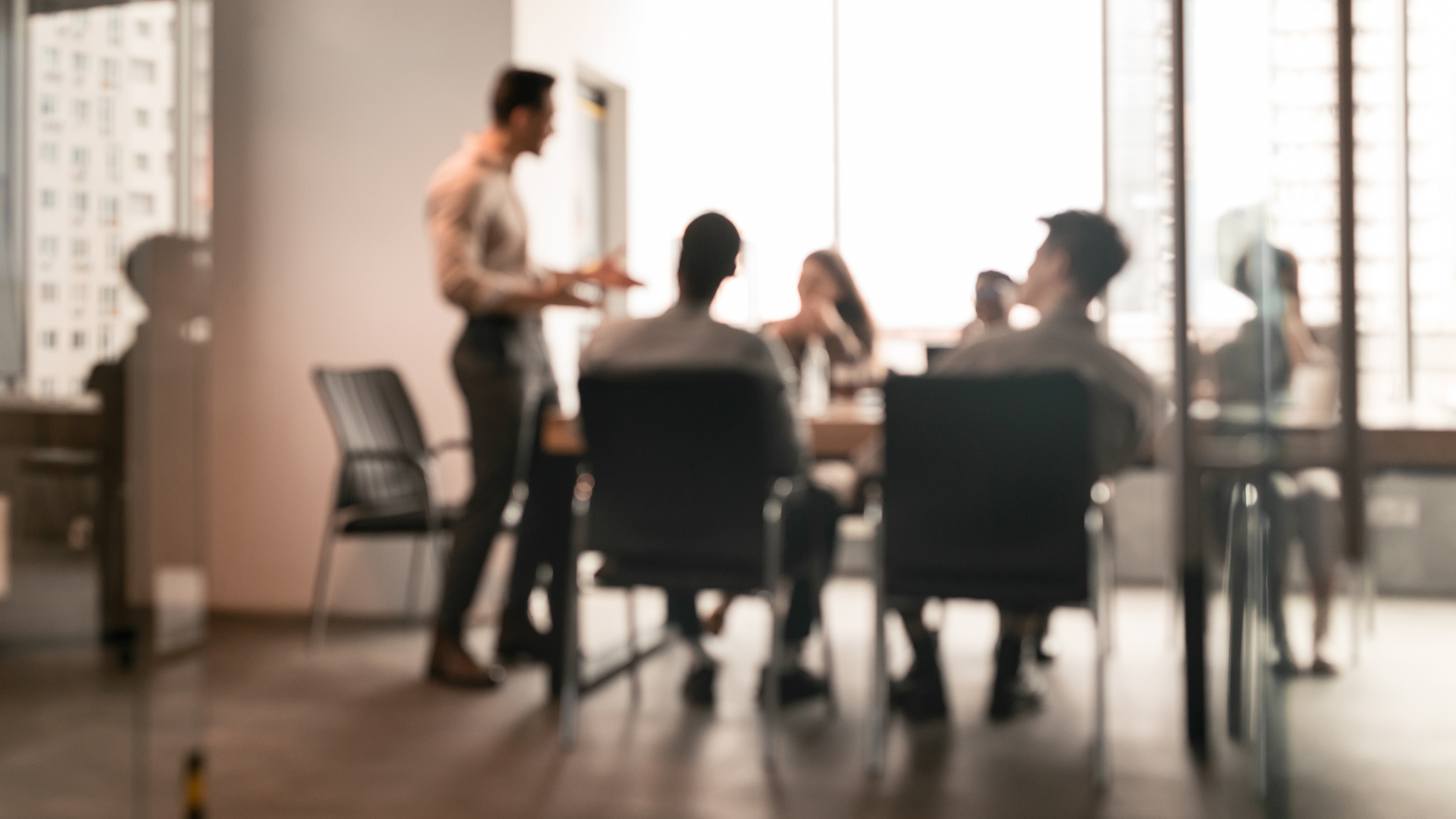 An office team holds in a meeting in a conference room.