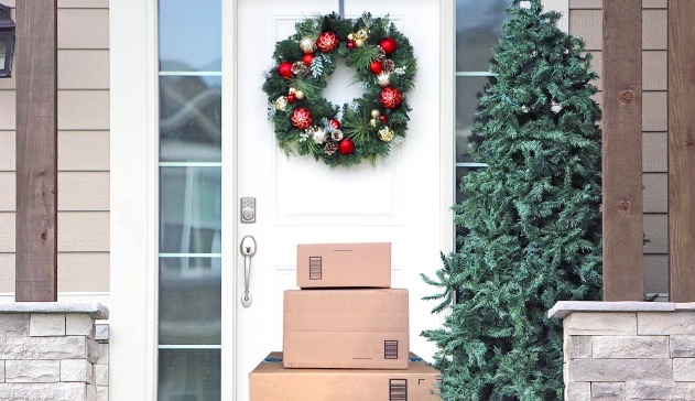 Cardboard packages are piled on a front door step.