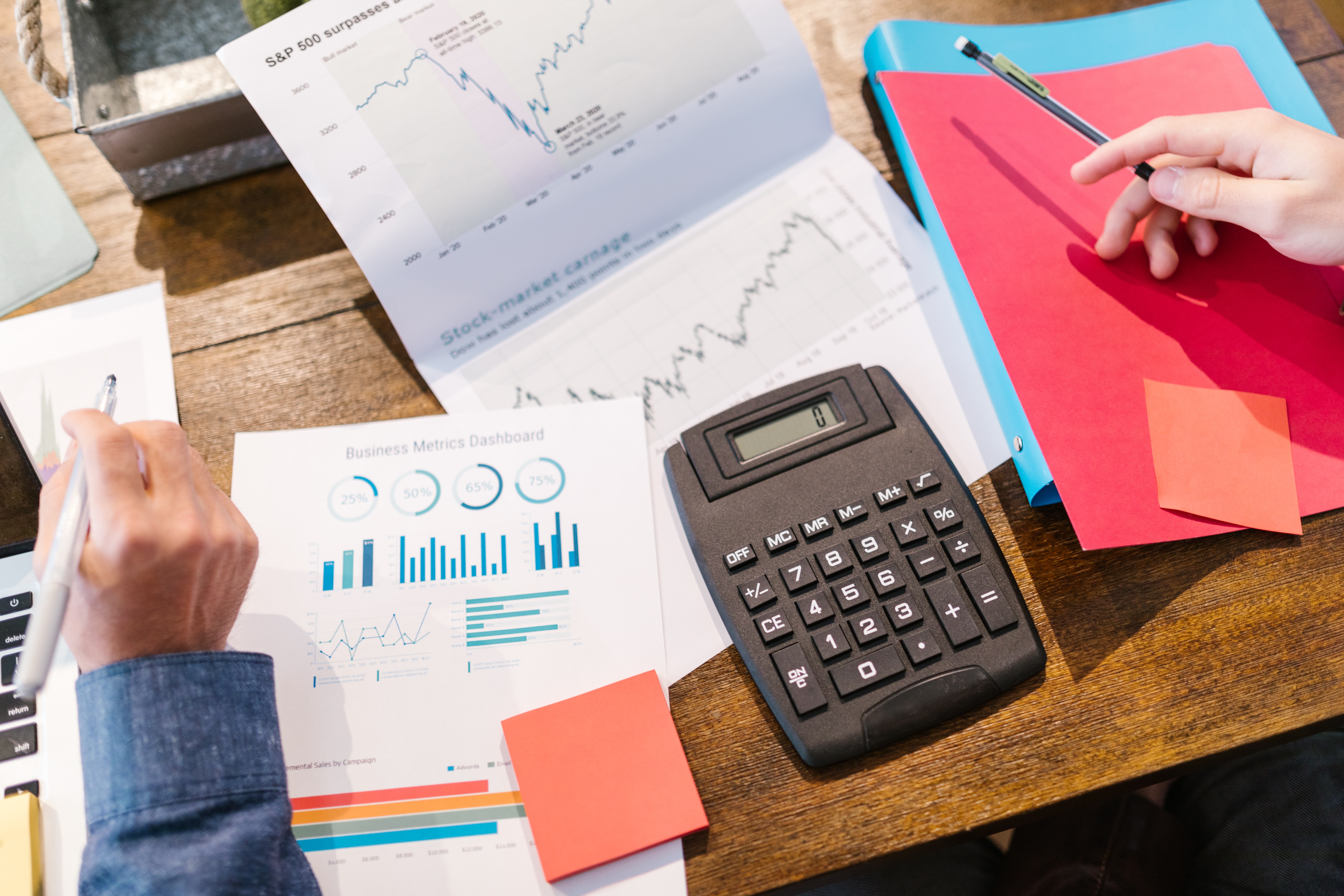 Business papers and a calculator lay on a desk.