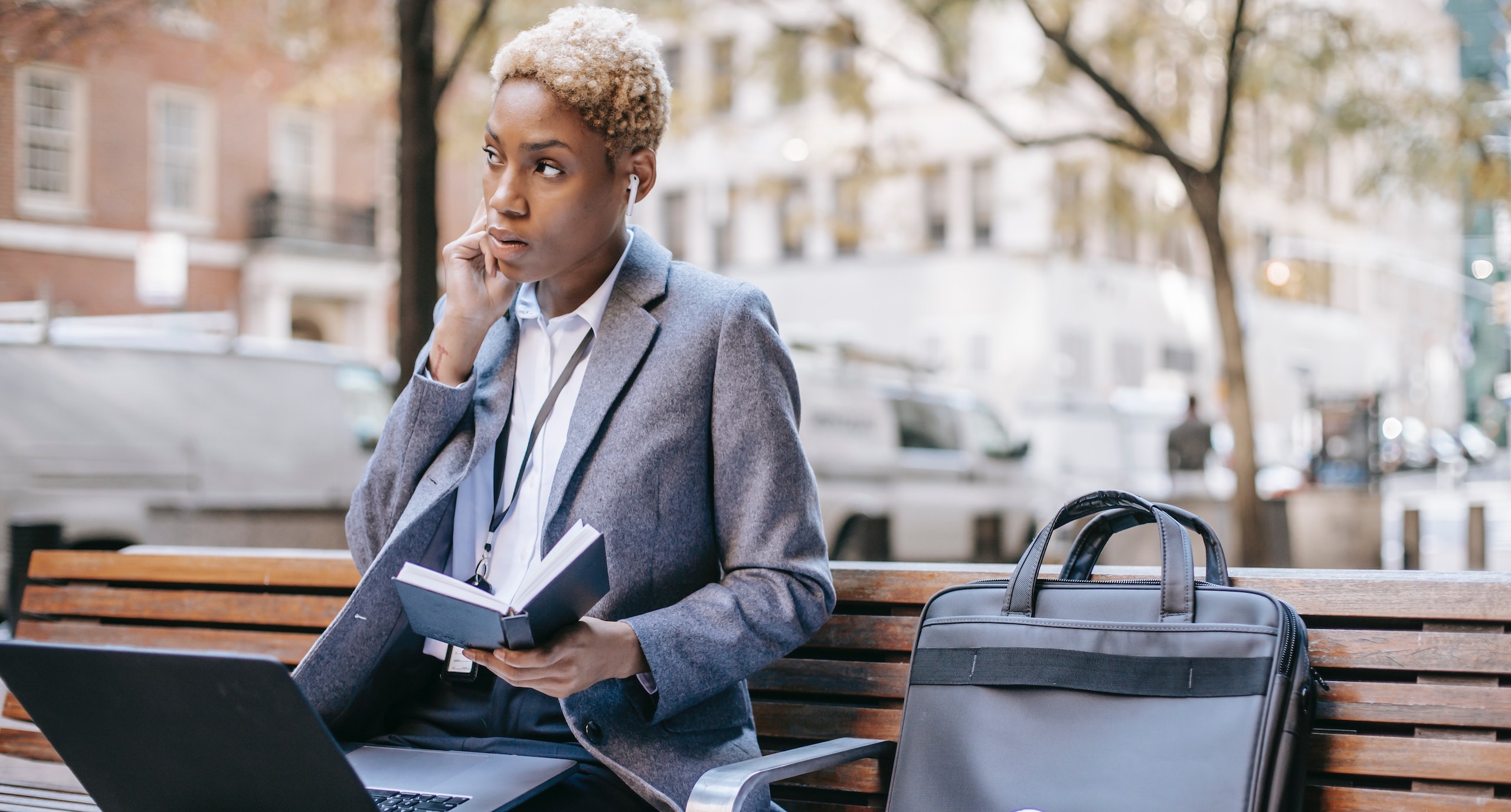 Business woman sitting on bench working