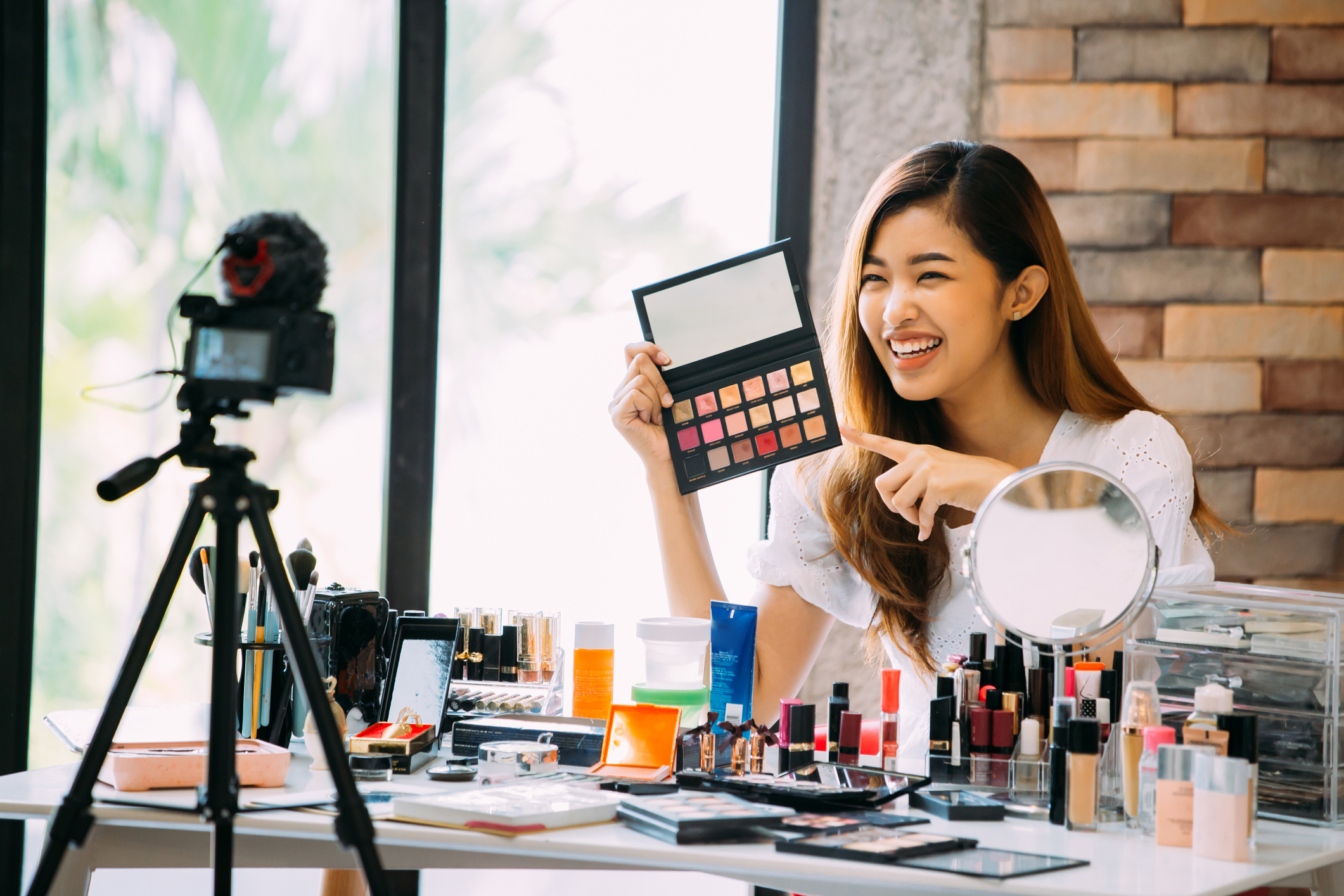 A female holds makeup 