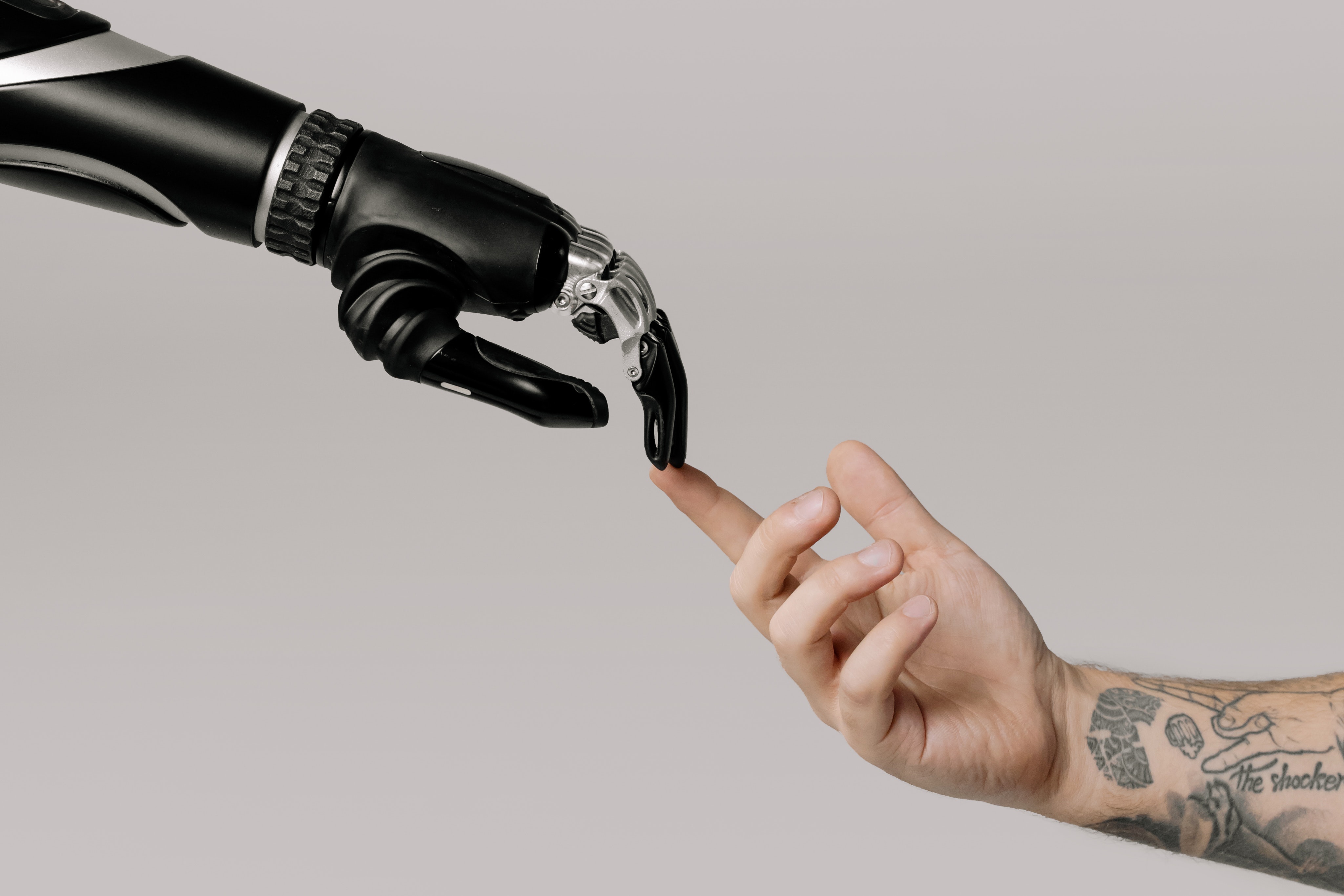 Man touching robot hand.