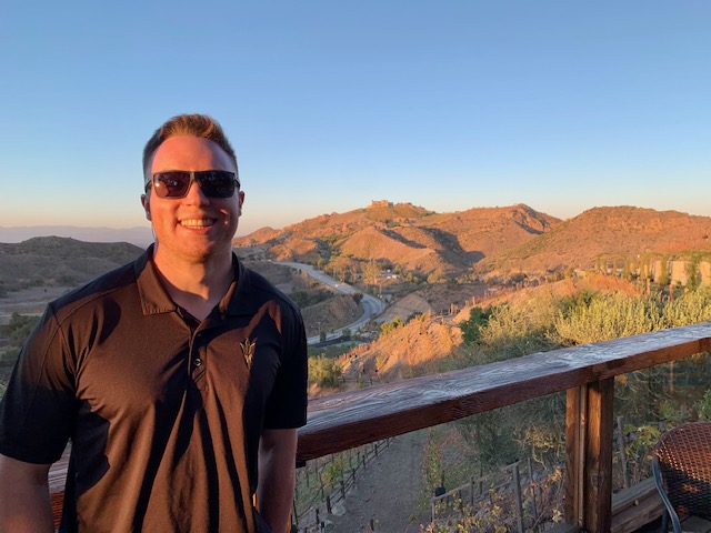 MS-FIN alumnus Will Tawney in front of a mountain