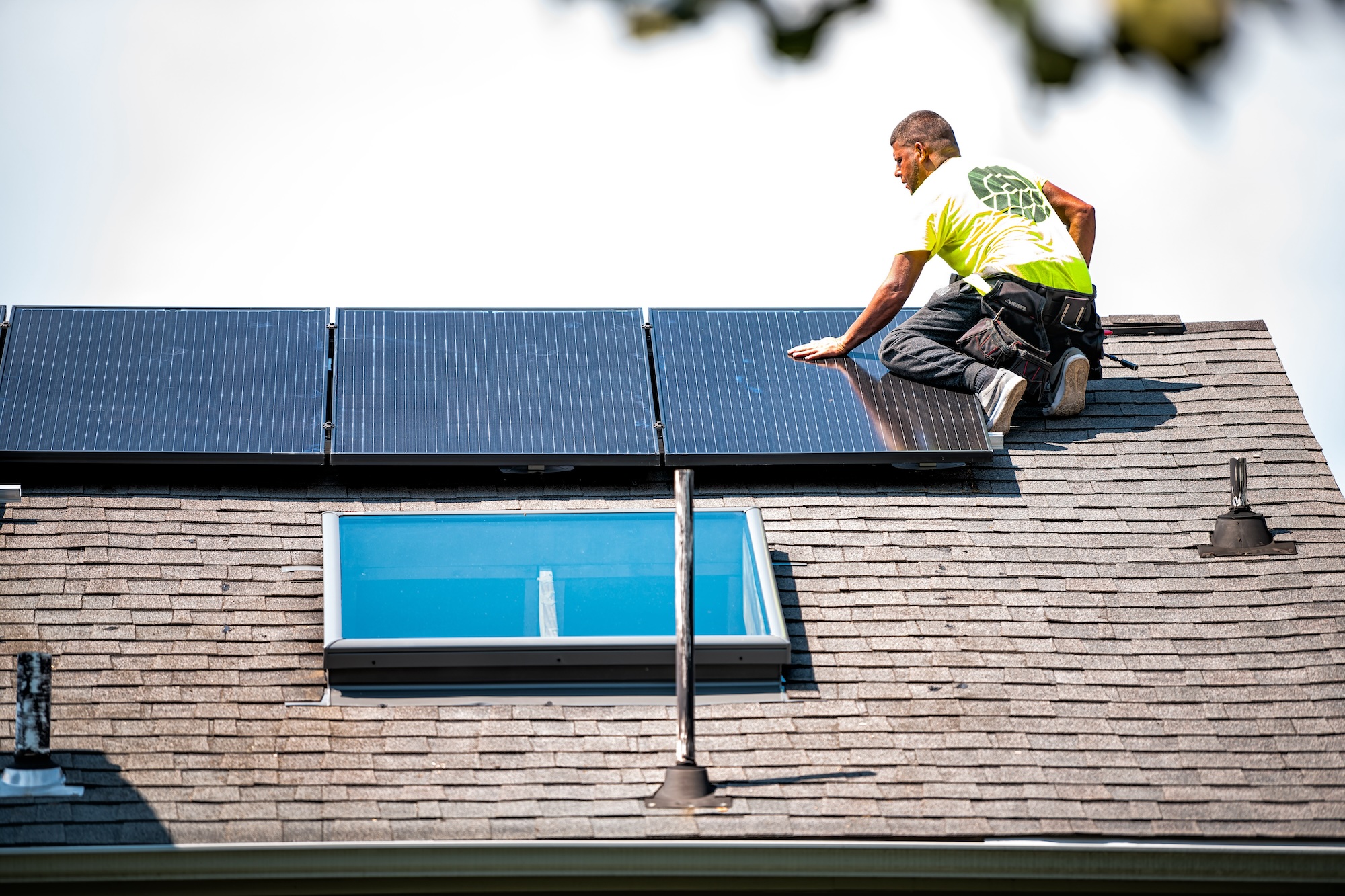man putting solar panels on residential property
