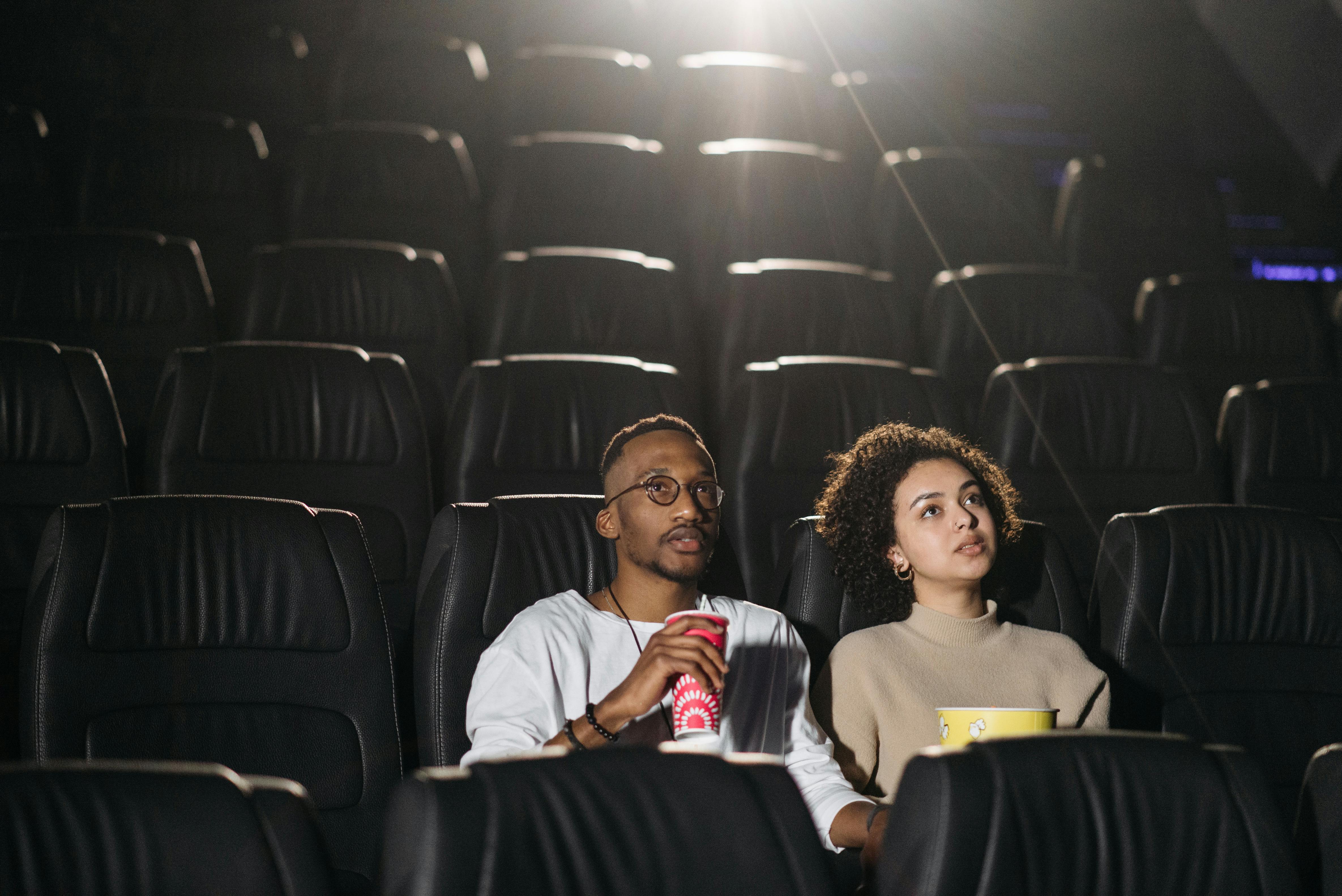 Two people in a movie theater.