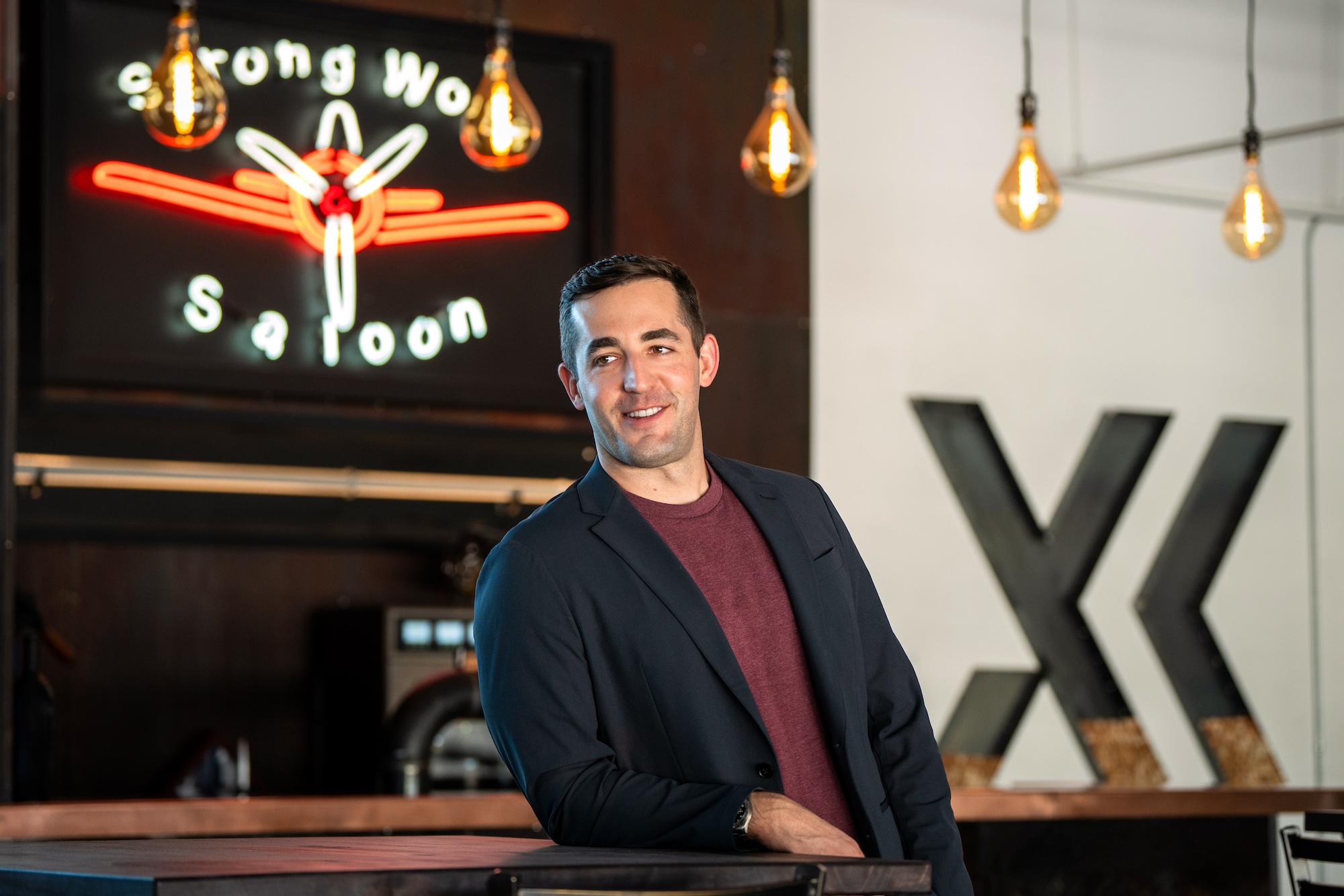 MBA alumnus Mike Shufeldt standing behind a bar and leaning on it