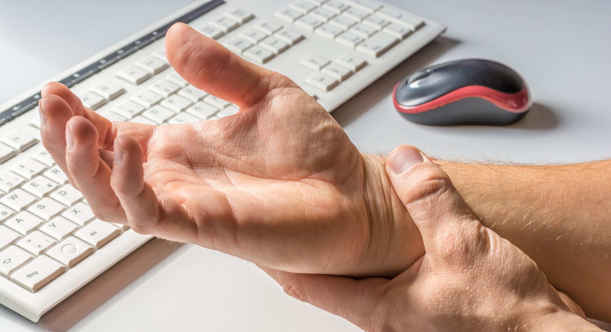 Person holding wrist.