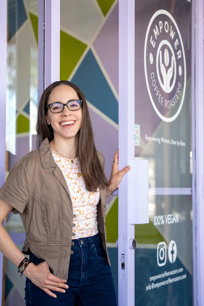 MBA alumna Denise Napolitano opening the door of her cafe