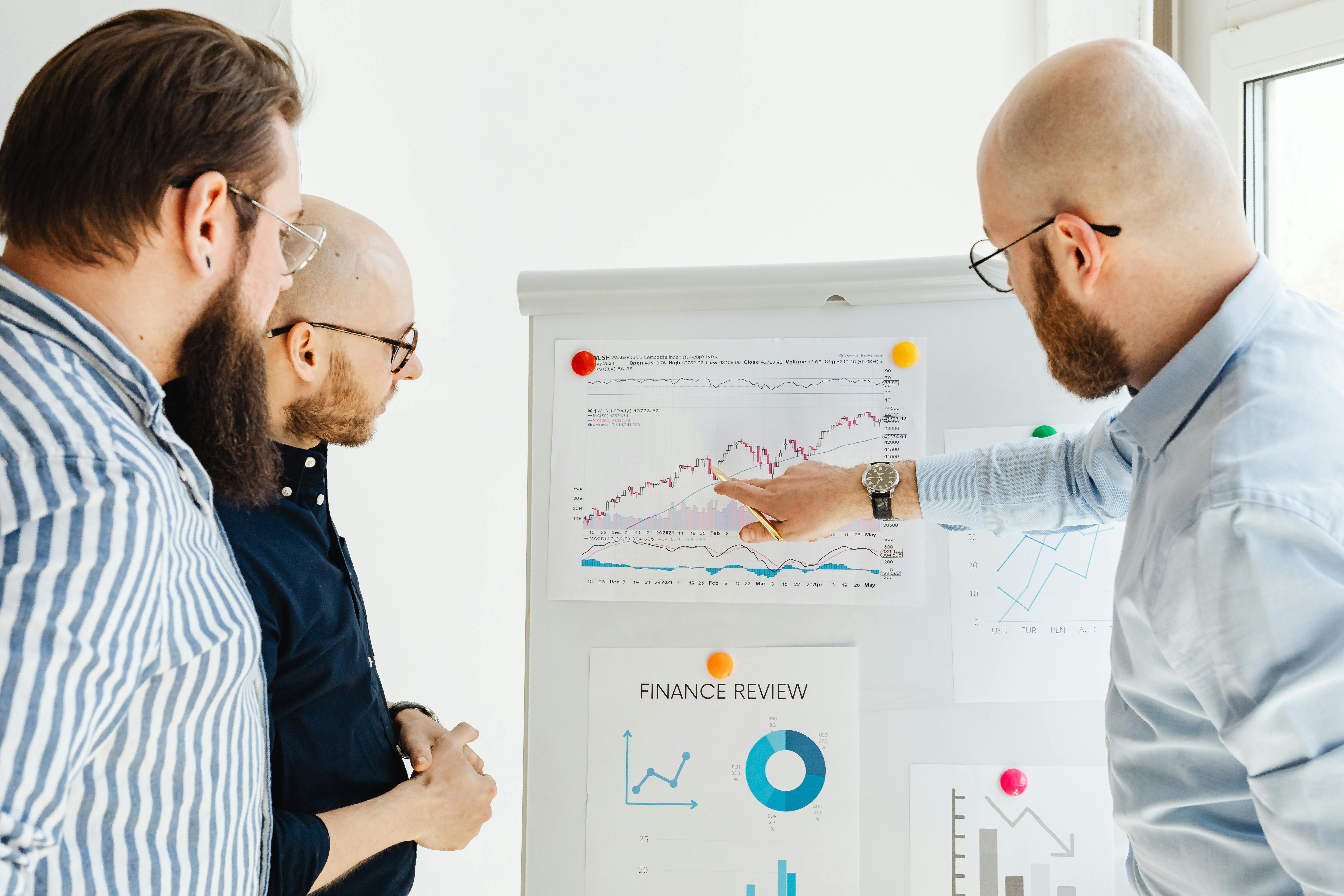 three men looking at data