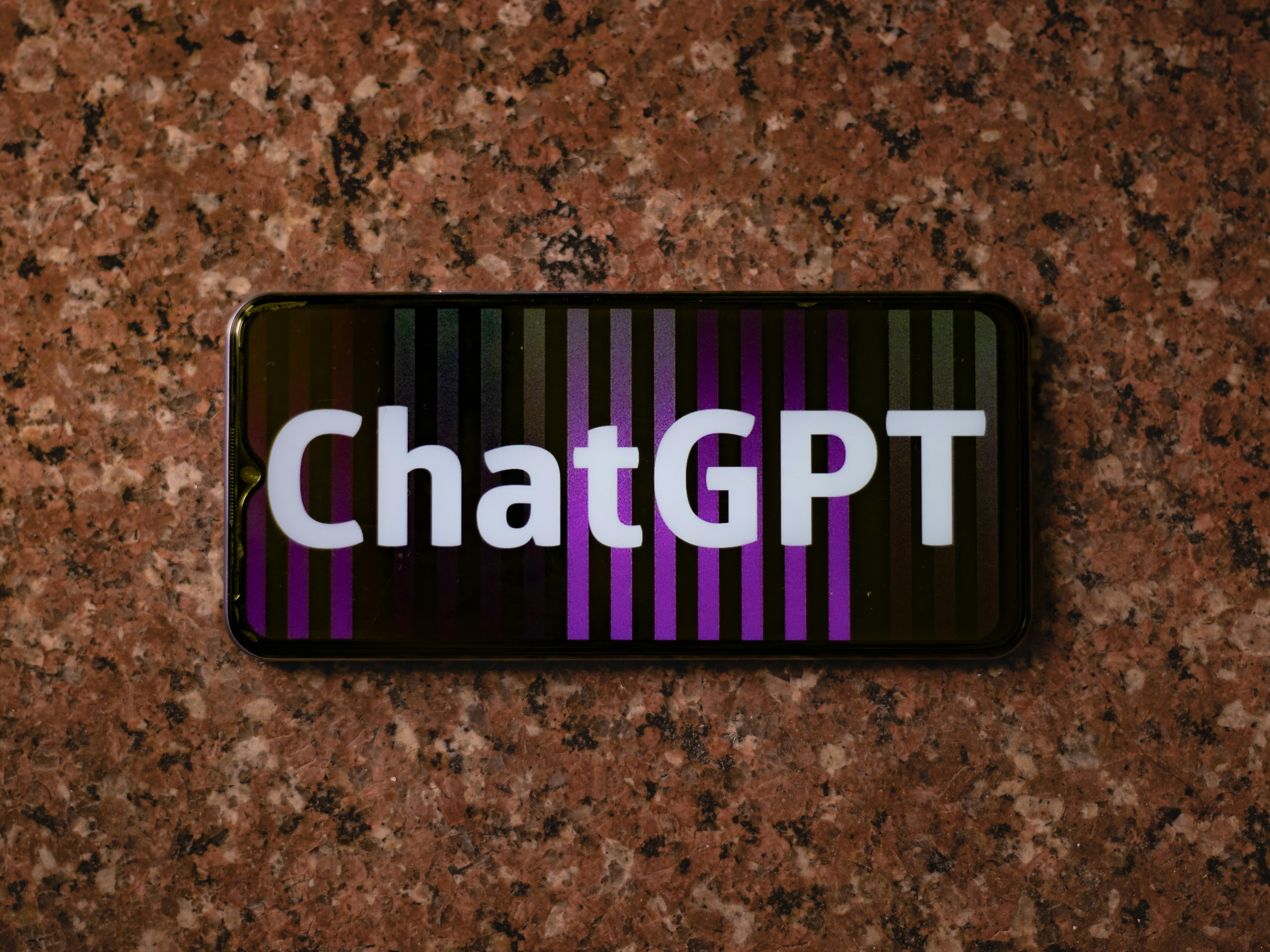 A phone displaying the text "ChatGPT."