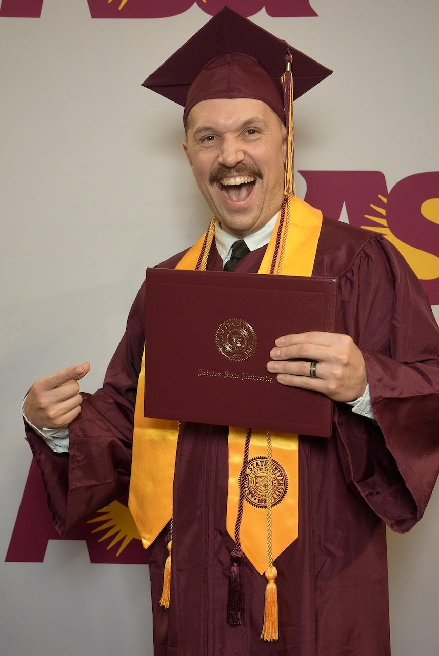 Global Logistics Management graduate Ryan Wilson celebrating in his cap and gown