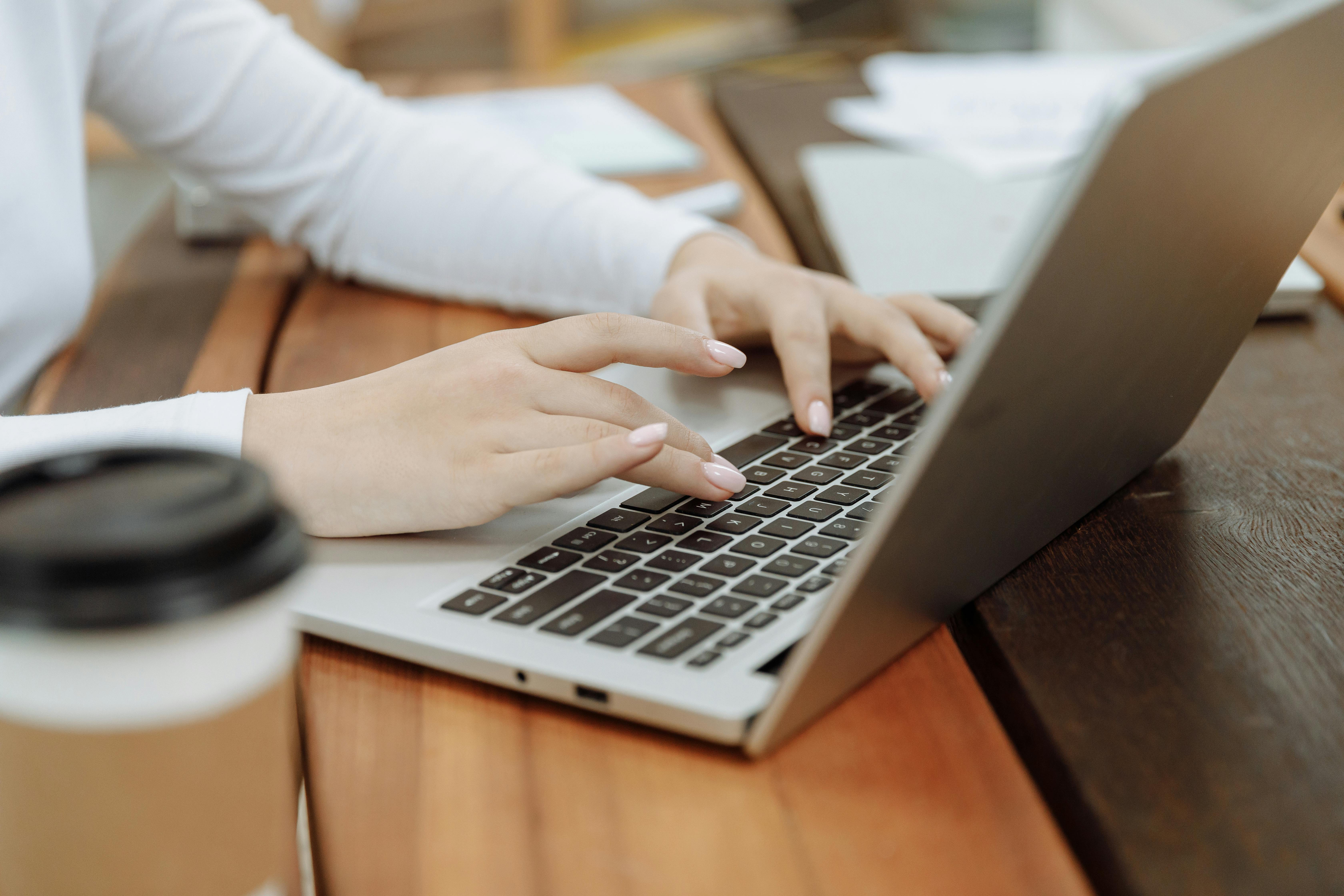 Person typing on a laptop.