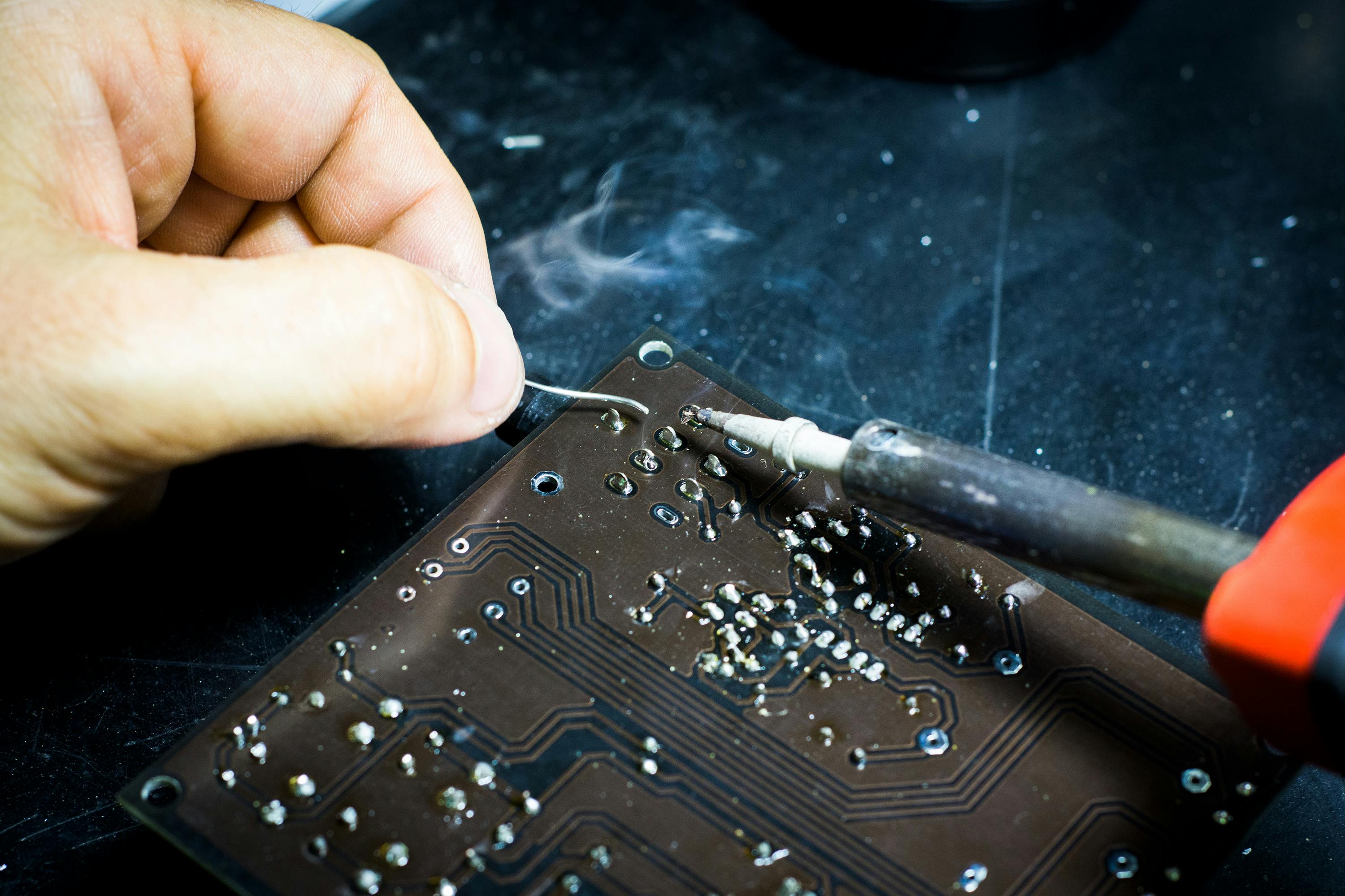 Person working with a chip and circut.