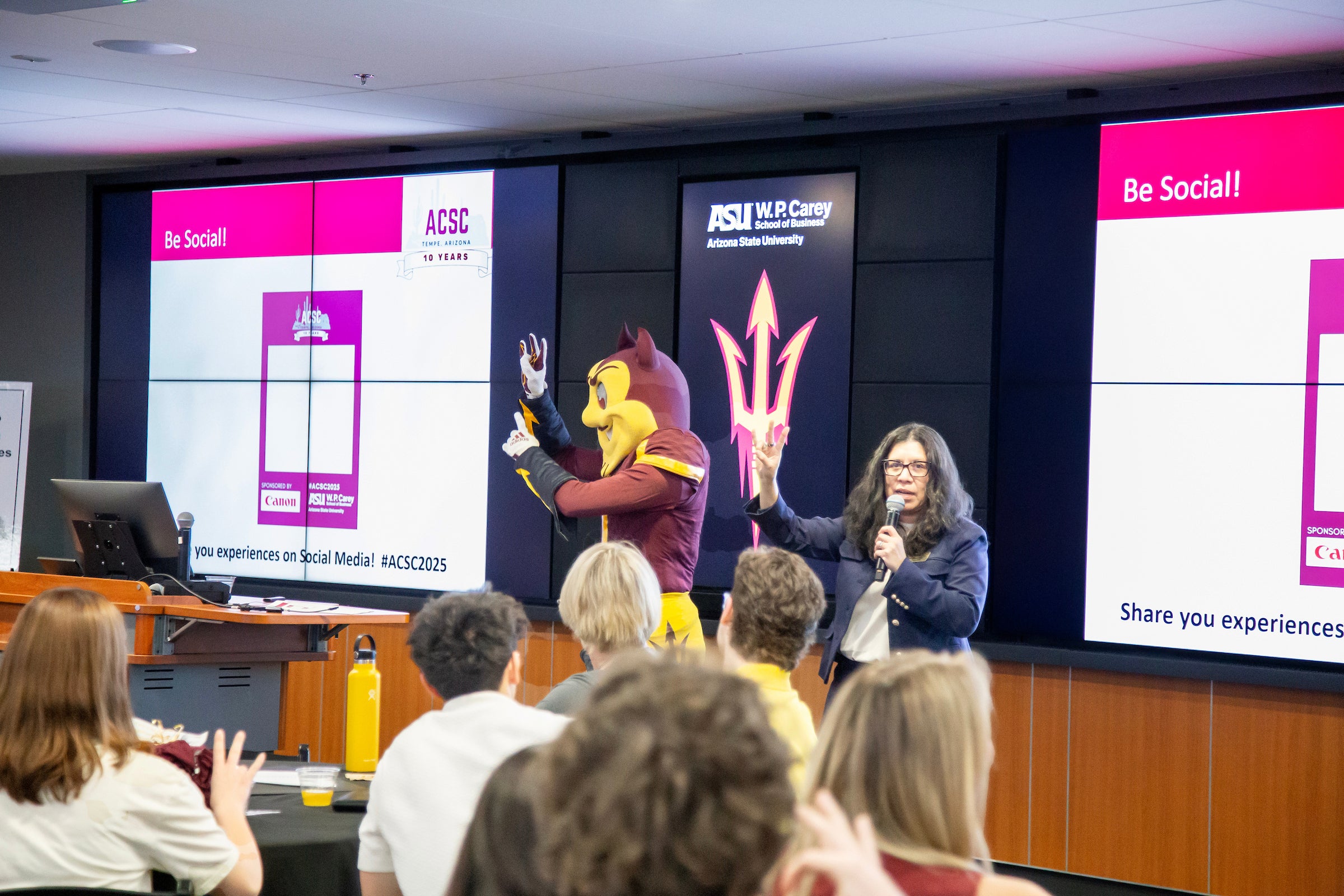 Detra Montoya and Sparky welcome students to the event.