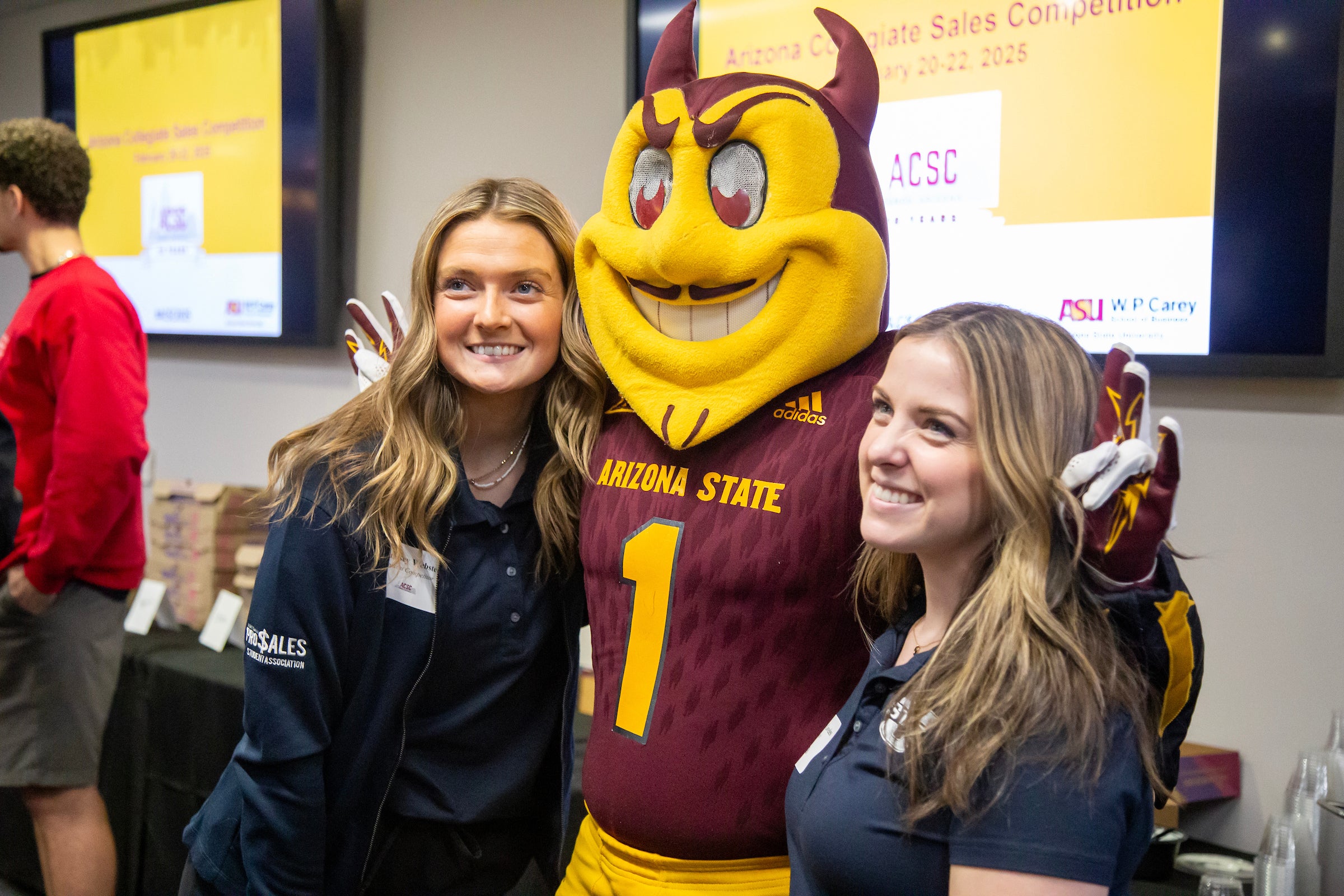 Student competitors pose with Sparky during the ACSC welcome event.