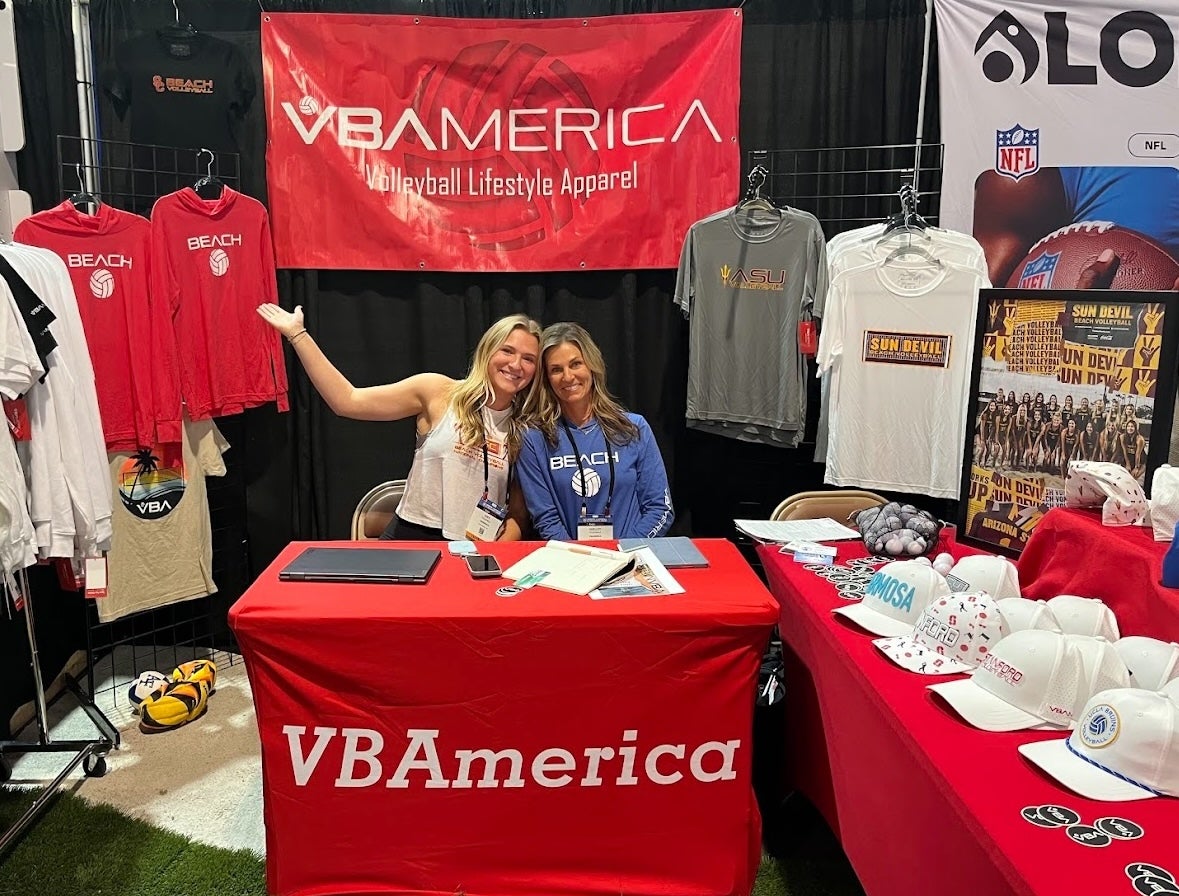 MS-EI student Kate Fitzgerald at a convention in a booth for her volleyball clothing brand VBAmerica