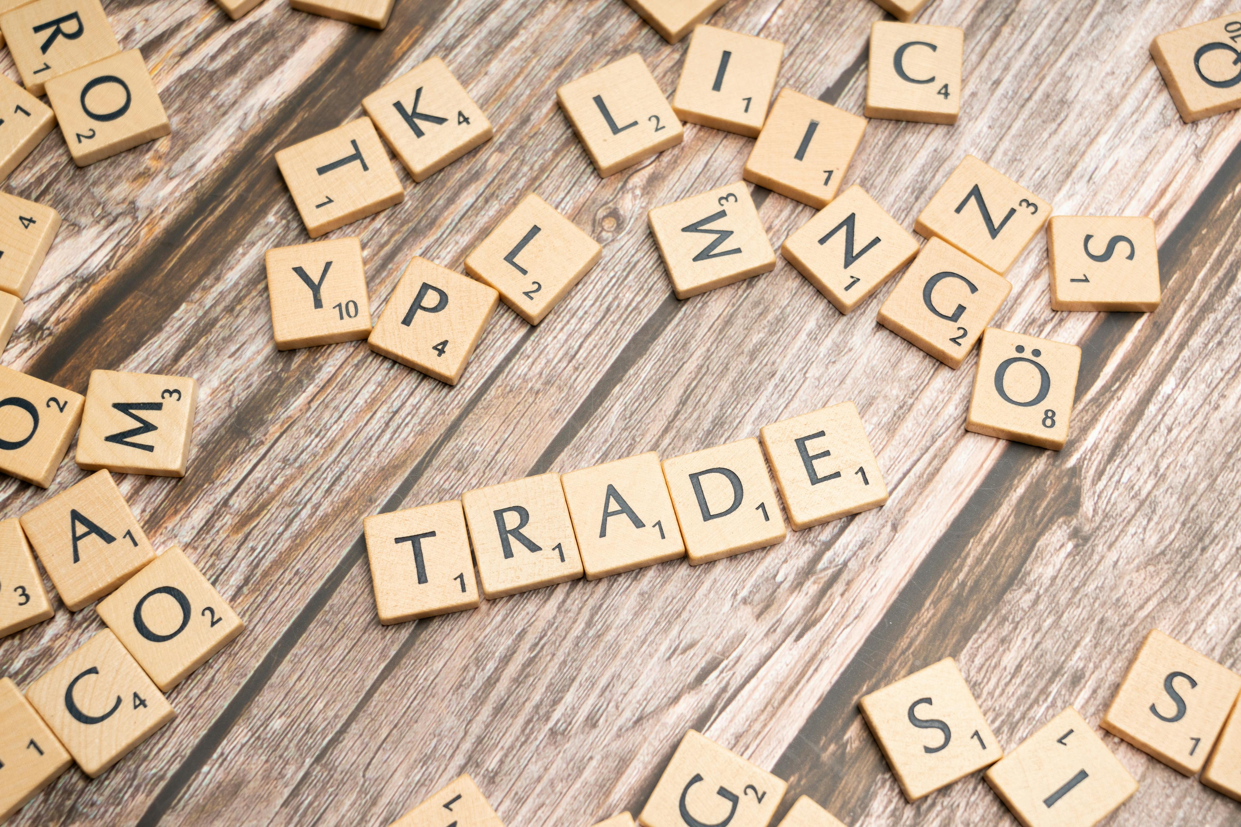 The word "trade" spelled out in scrabble letters.