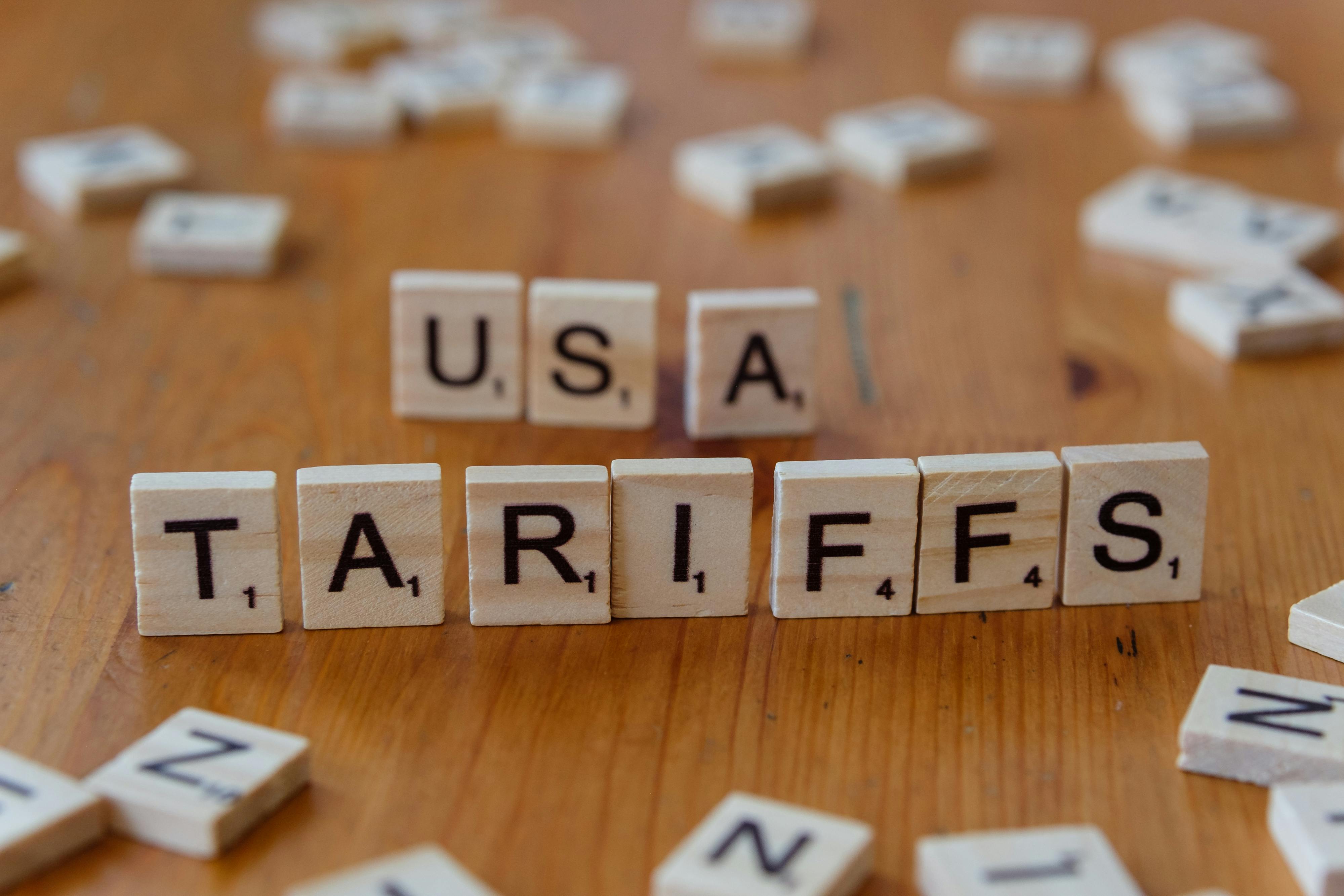 The words "USA Tariffs" spelled out in scrabble letters.