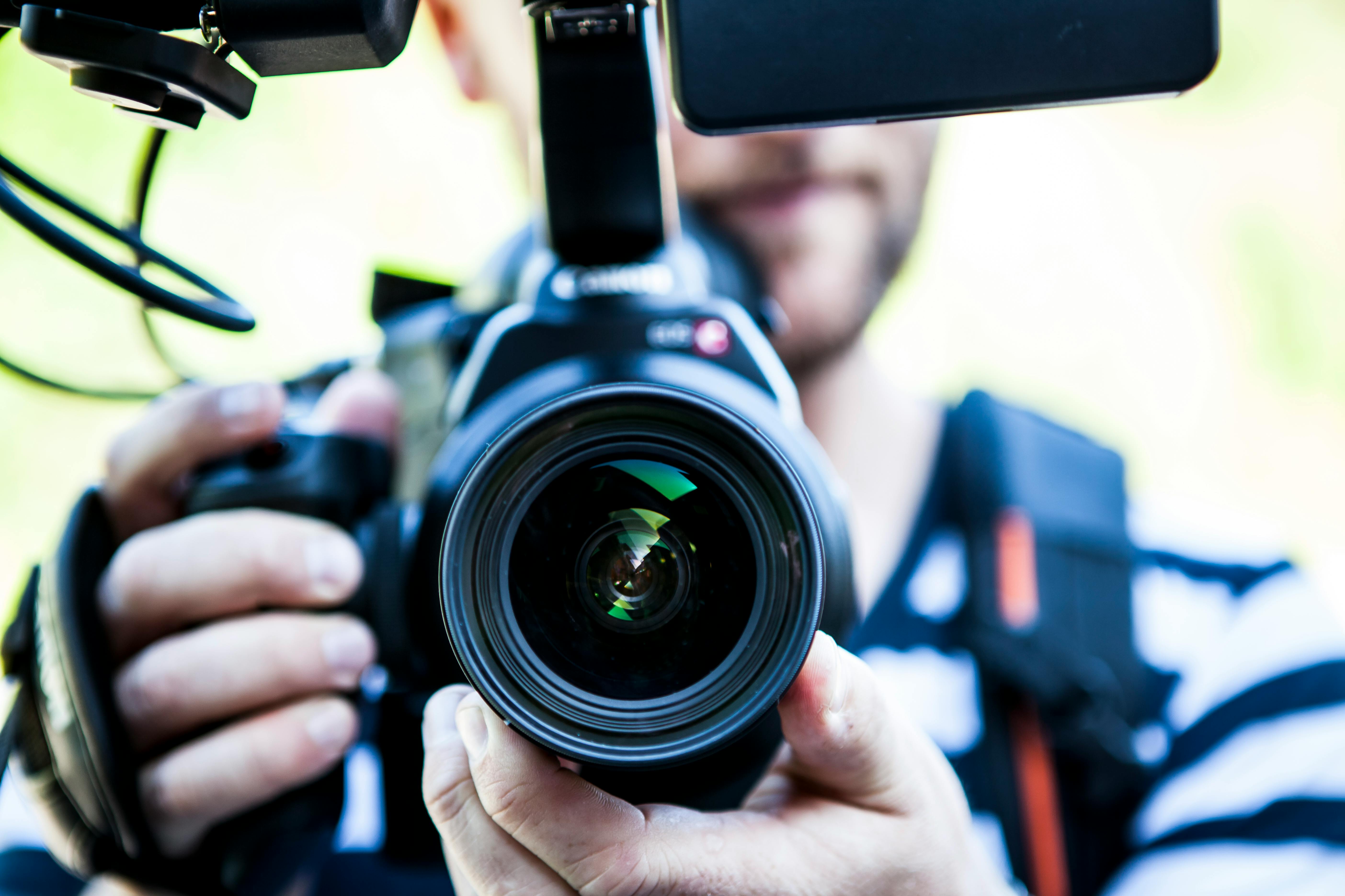 A person holding a TV camera.