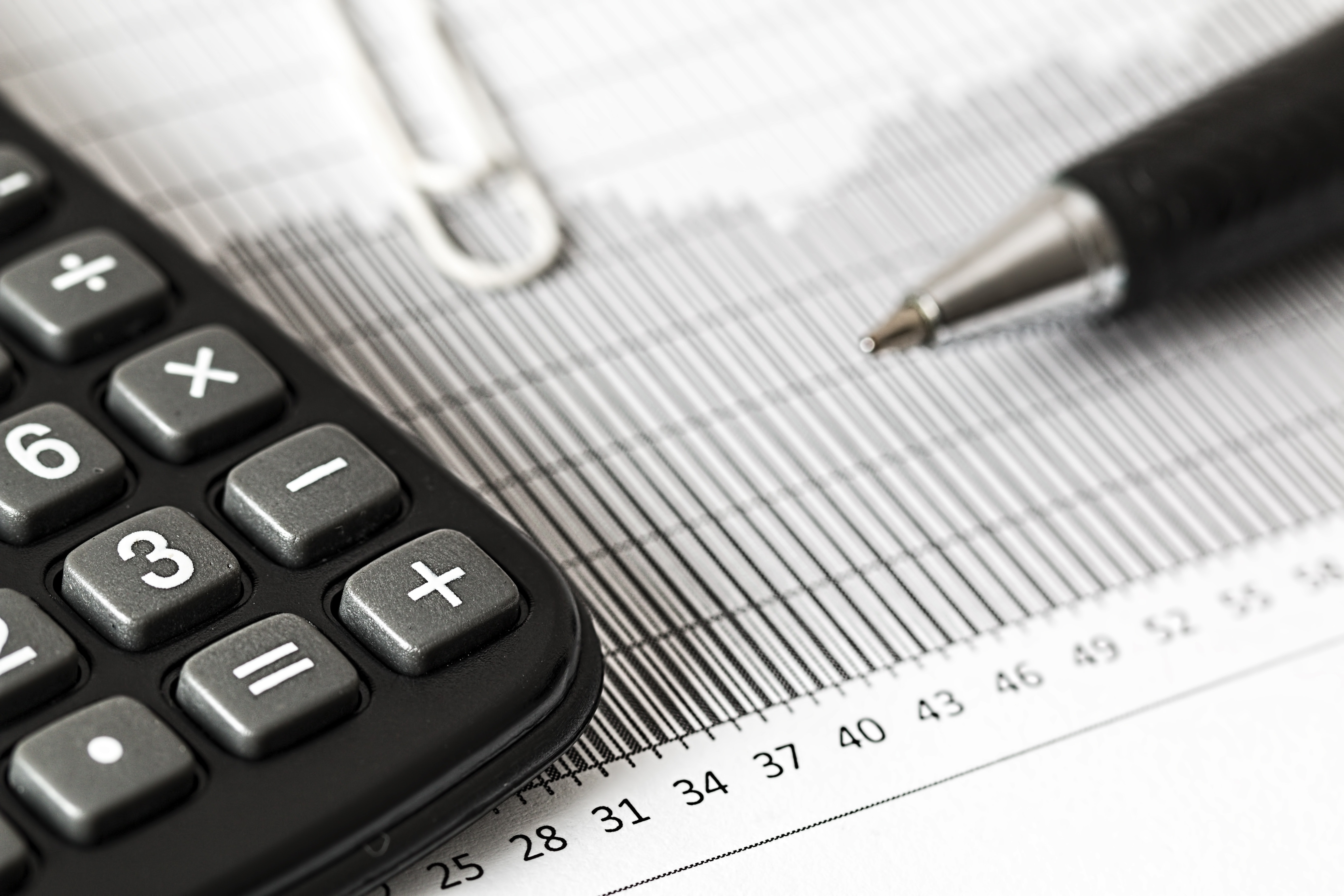A pen, calculator, and tax tables.