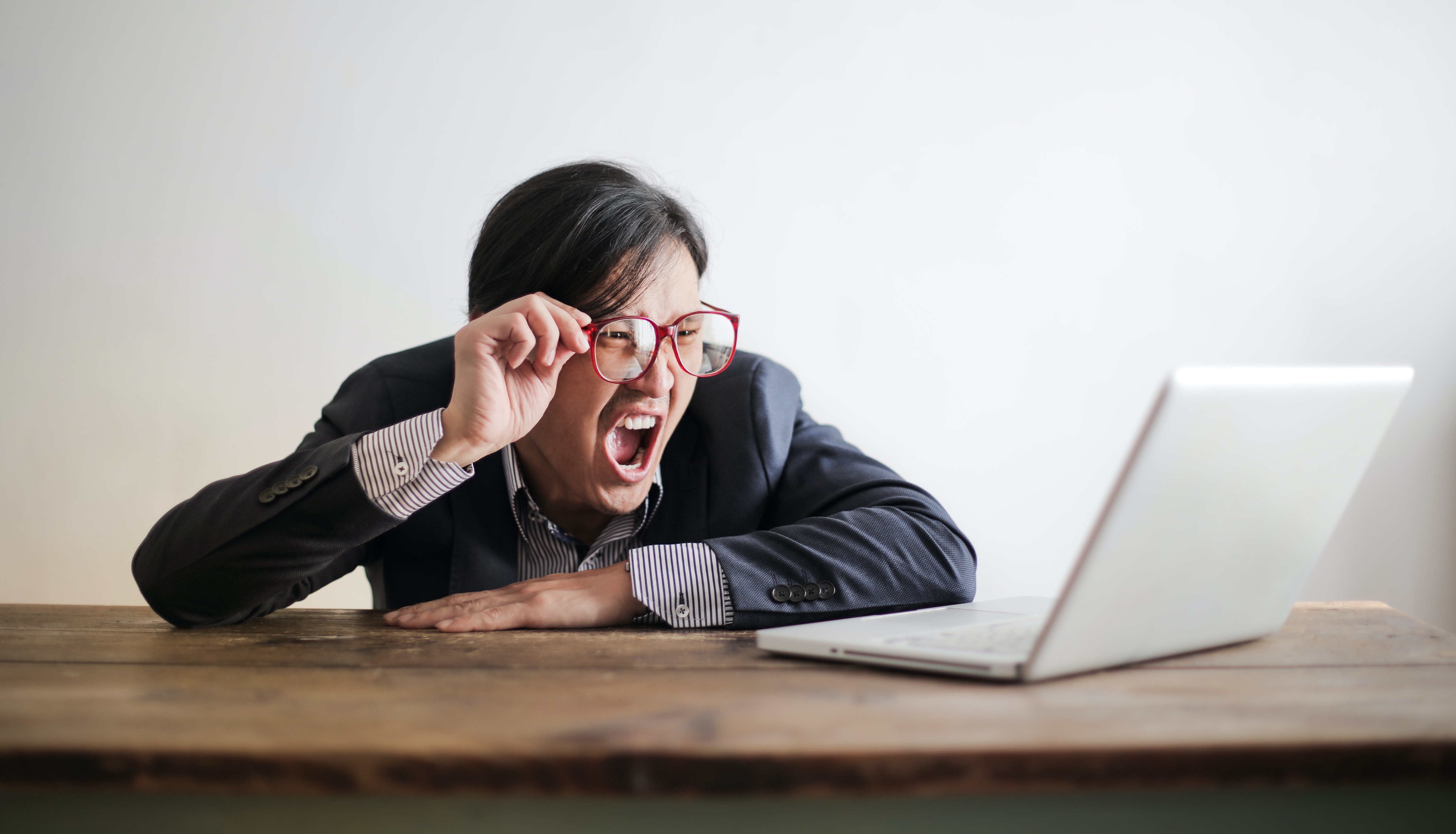 Angry person yelling at laptop