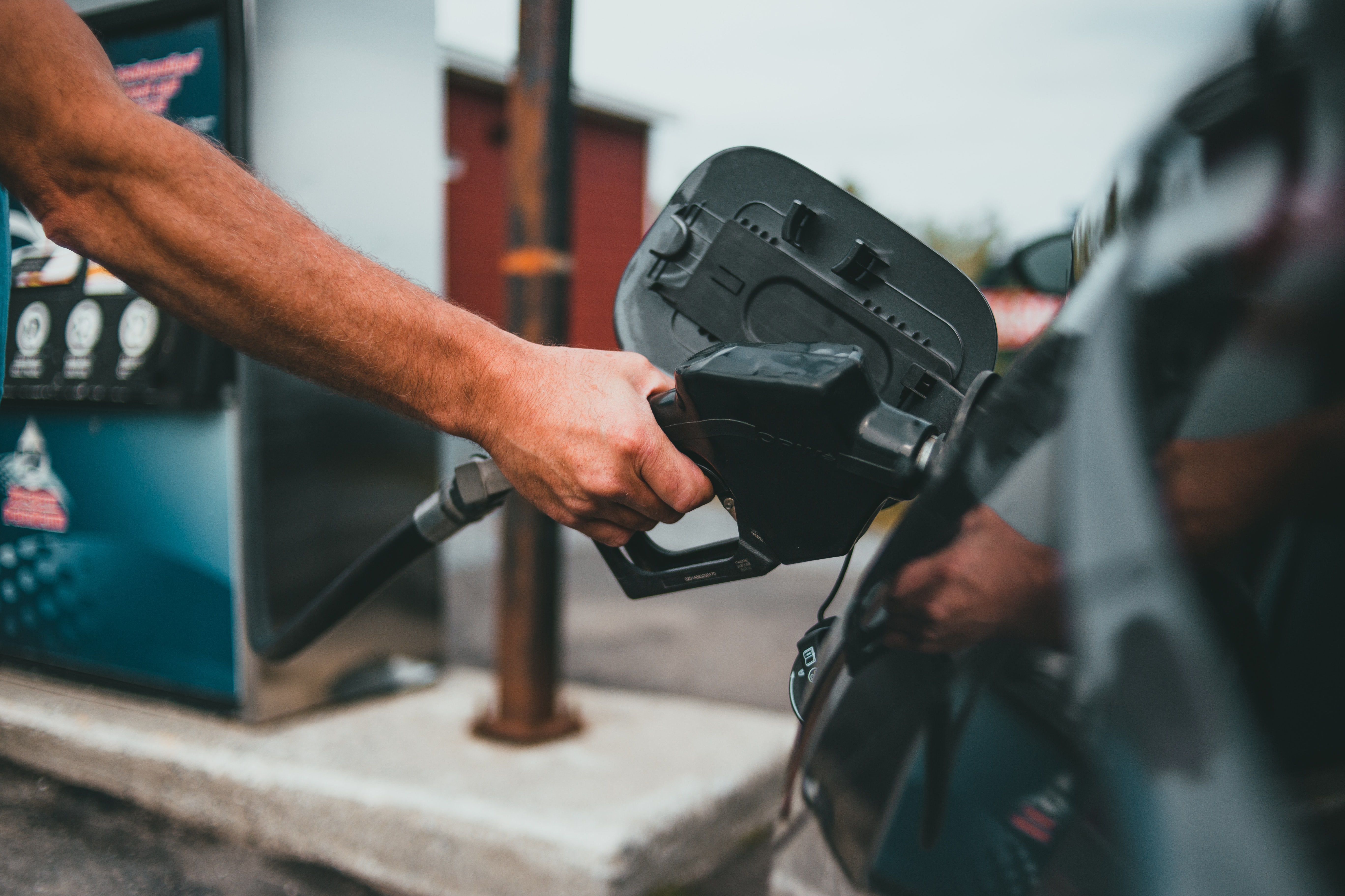 Man filling up car gas tank.