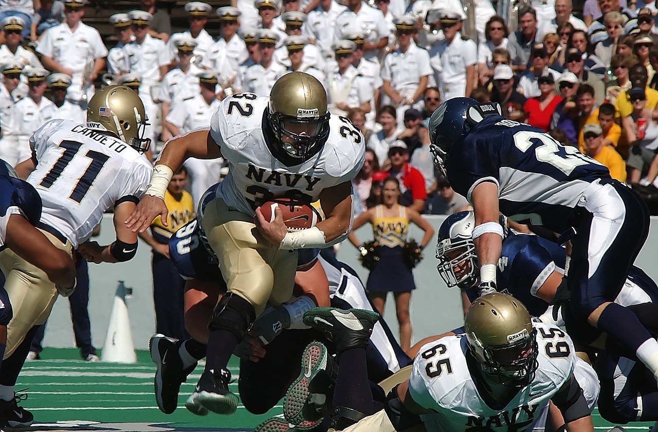 Football player running on field.