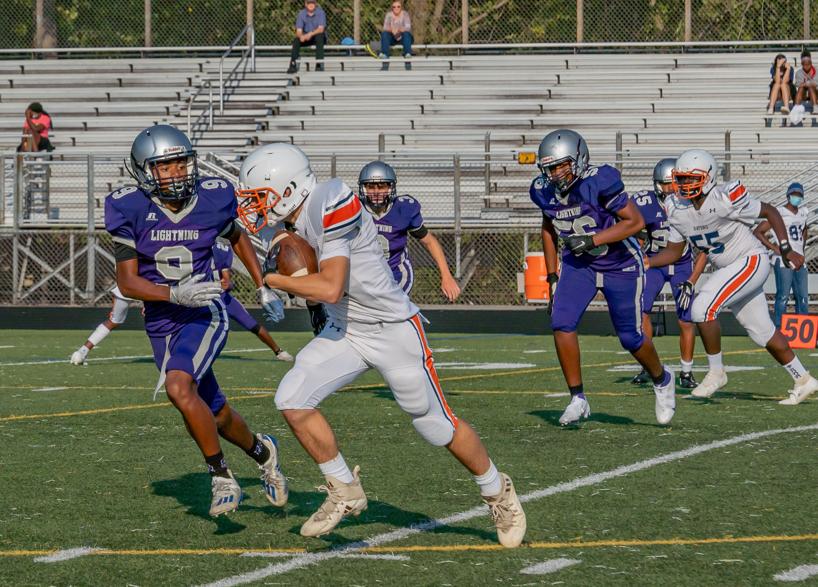 Football player running with football.
