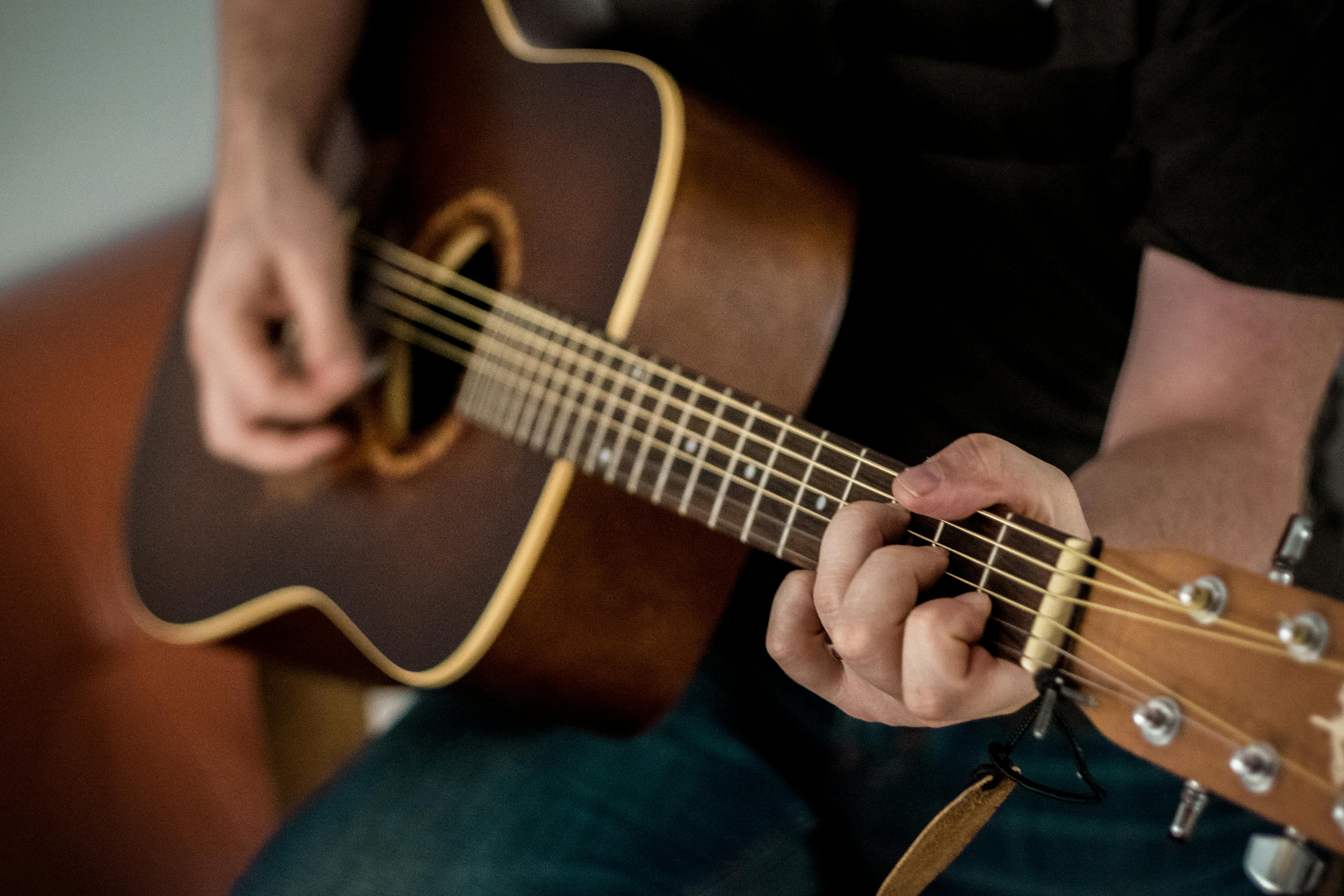 Person playing a guitar.
