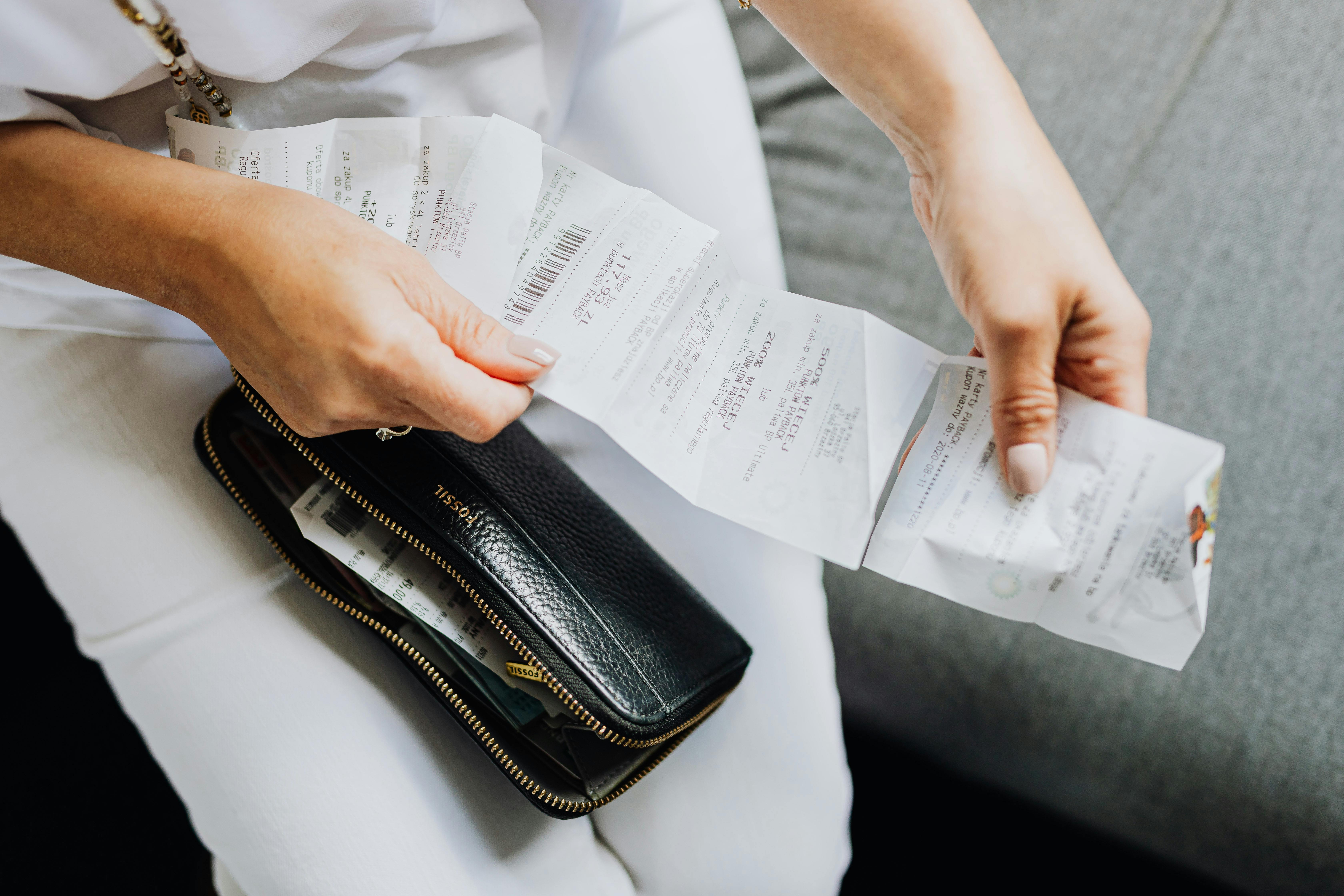 Woman holding a long receipt.