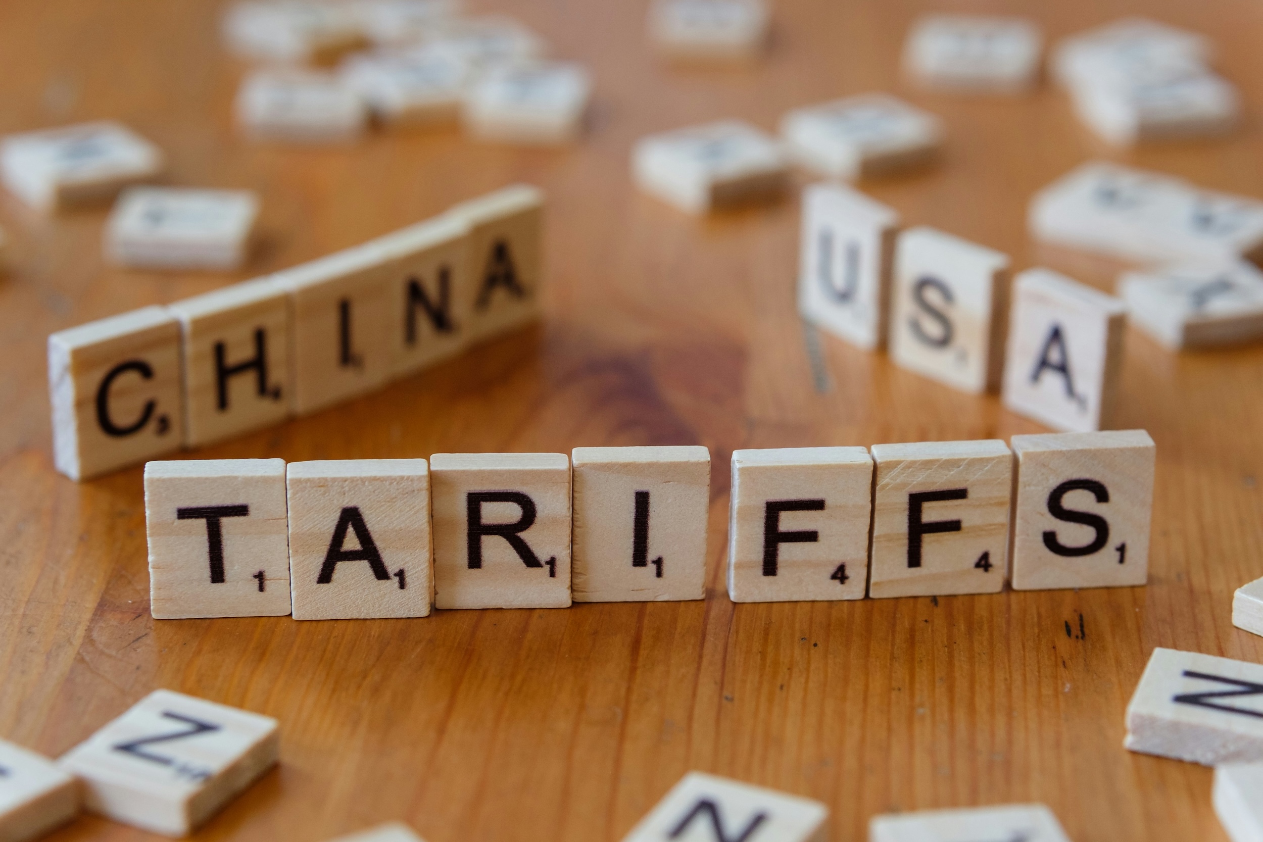 Photo by Markus Winkler of scrabble tiles spelling the words China, USA, and tariffs