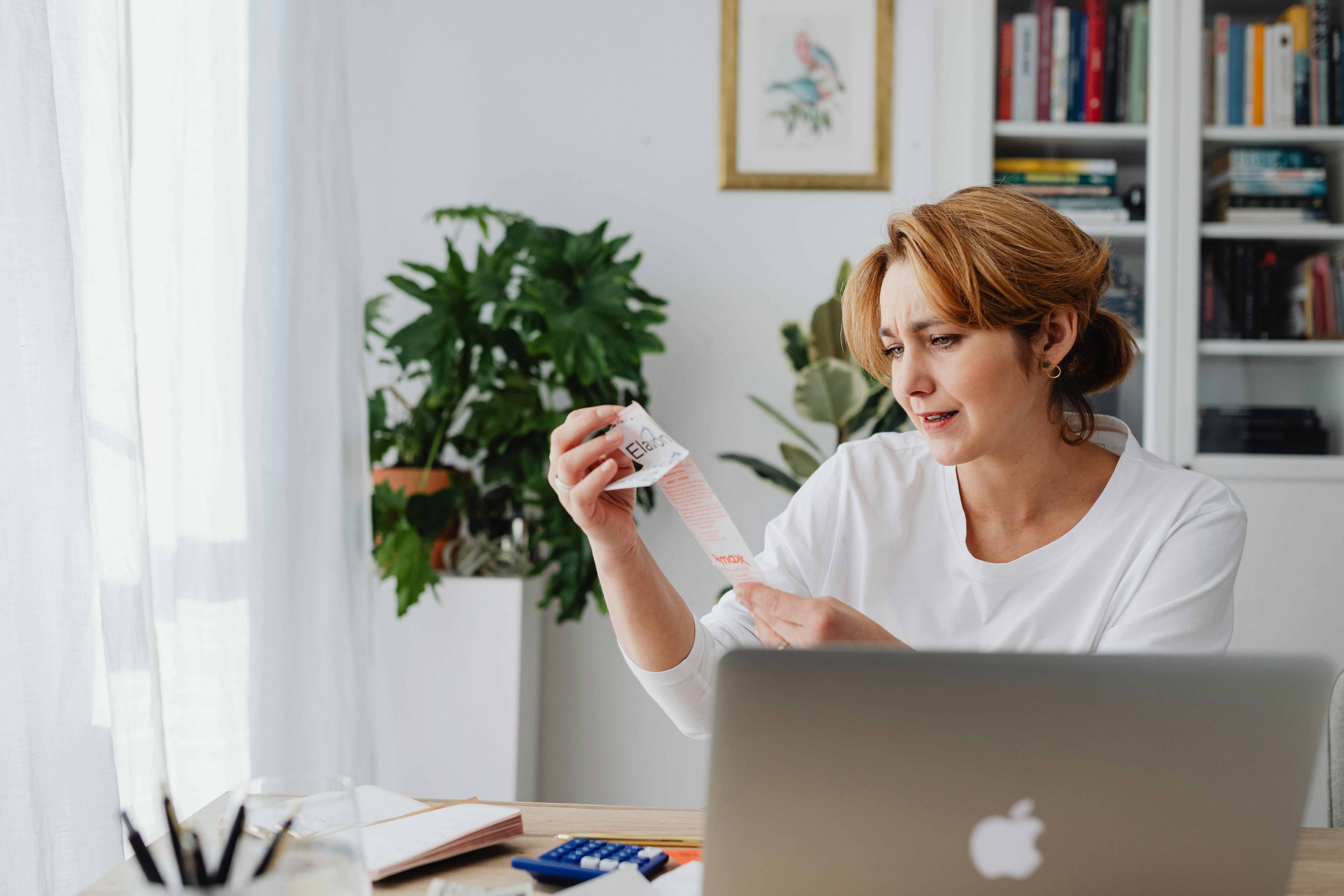 Woman looking at receipts. 