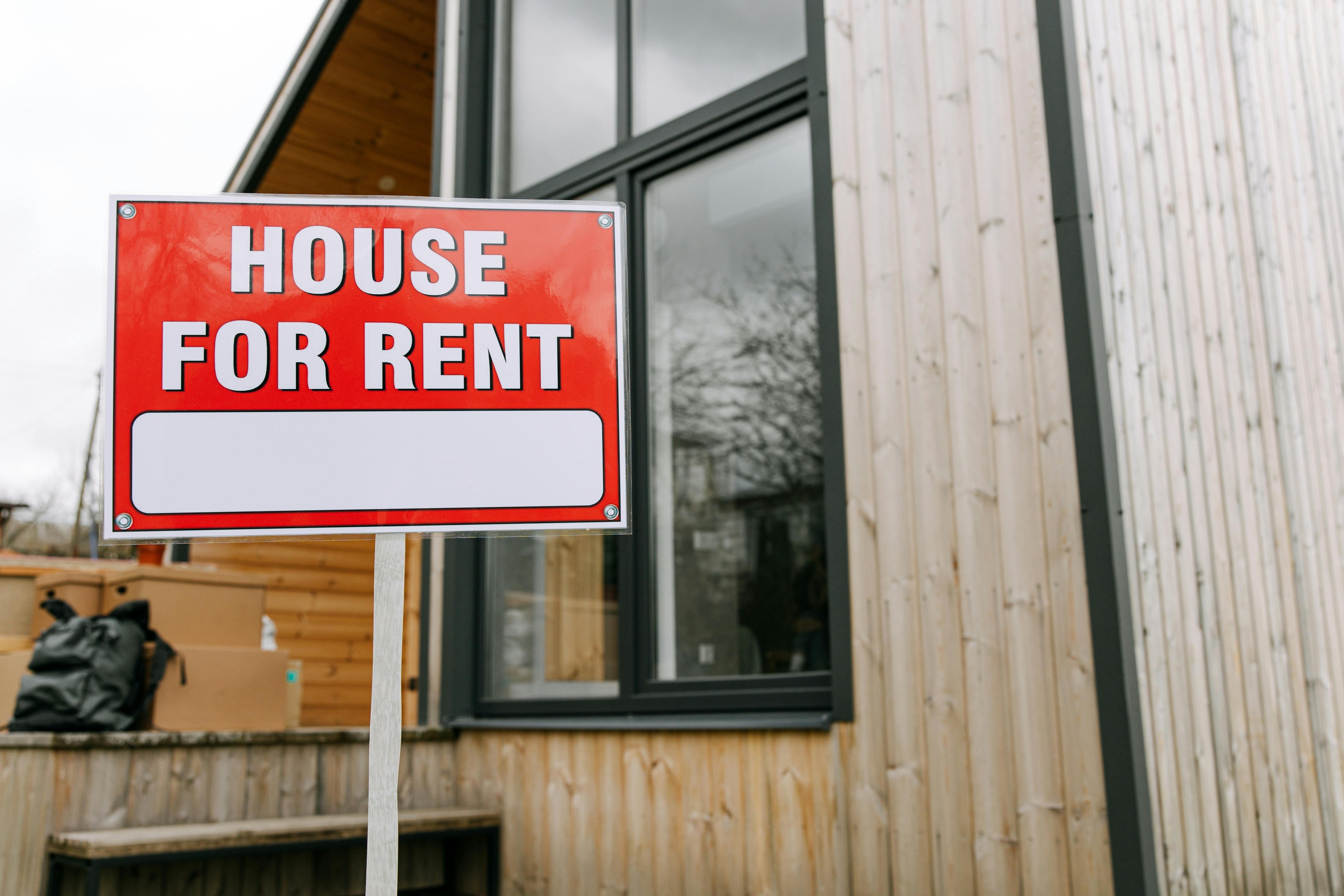 A "House for rent" sign.