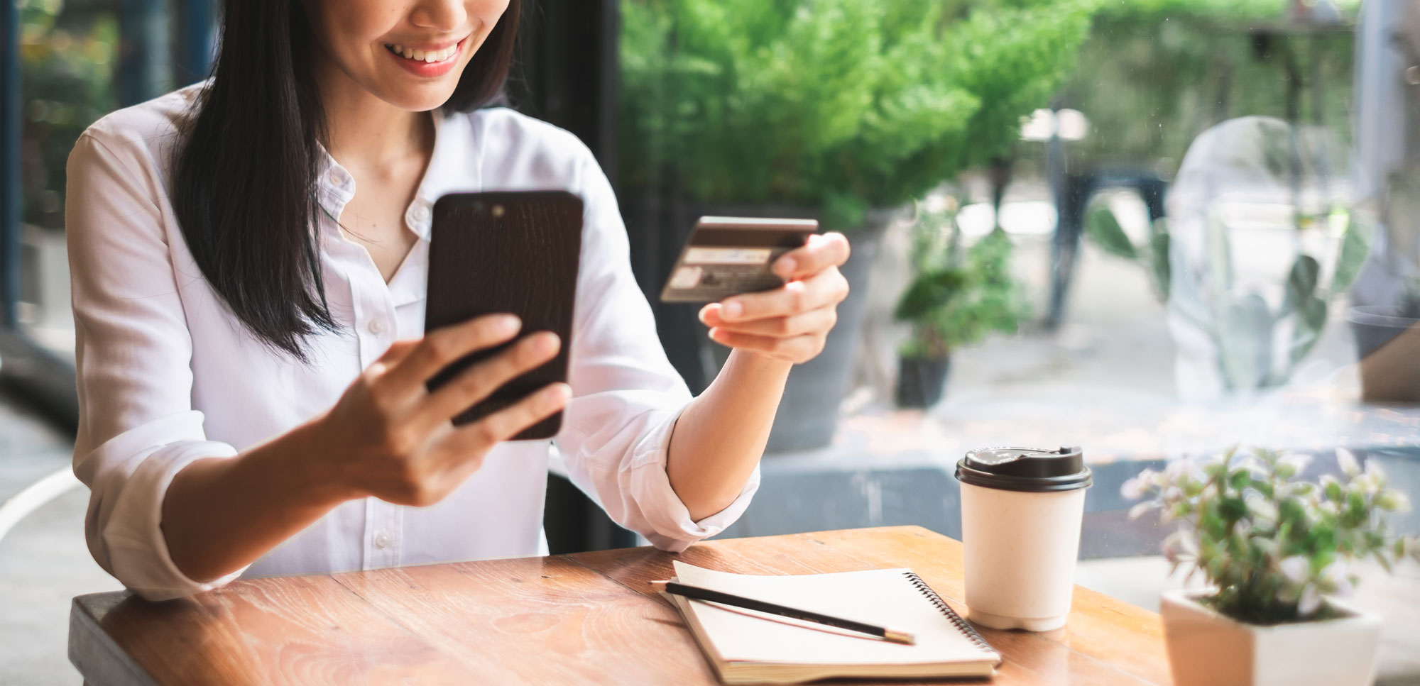 istock-1049808198-2.jpg Woman Online Shopping at a Cafe